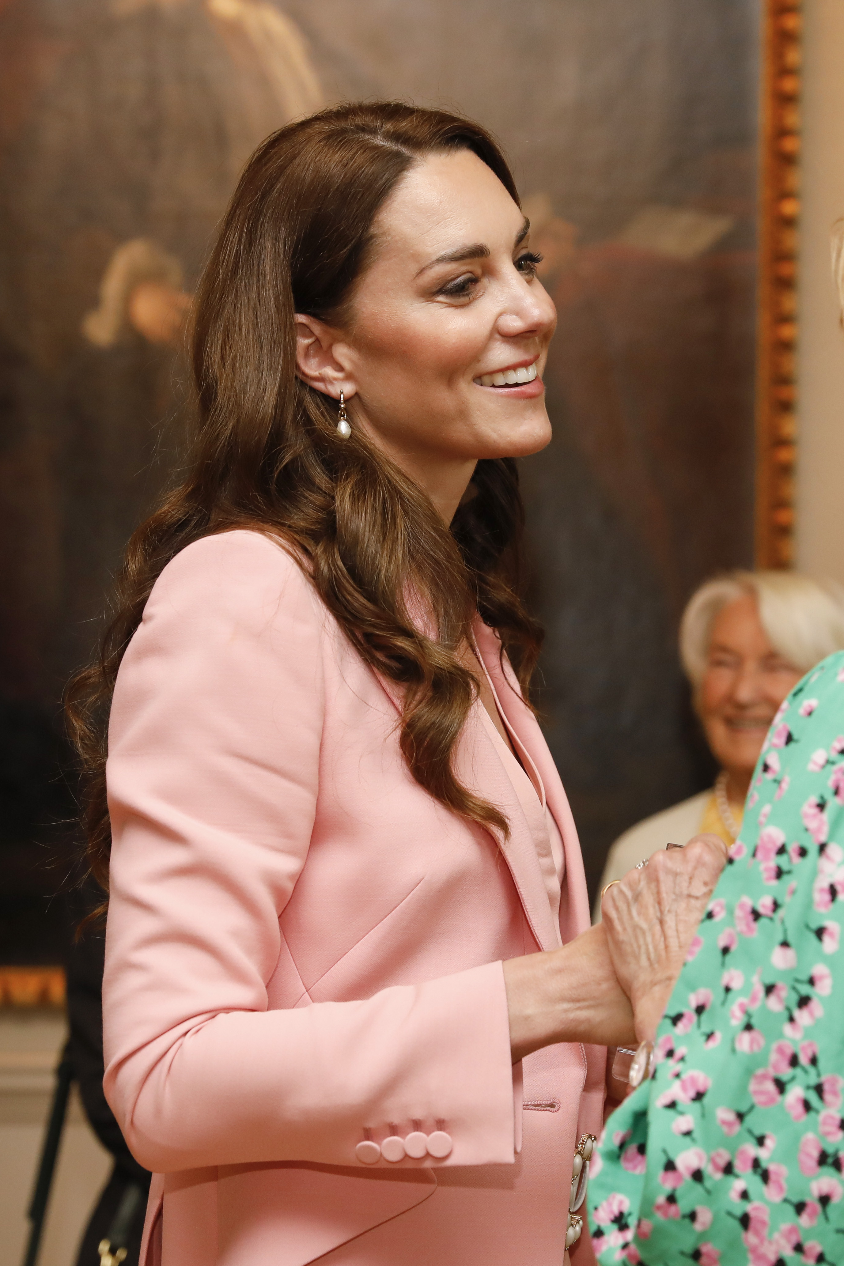 Catherine, Princess of Wales holds hands with a guest on her visit to the Foundling Museum in London, England, on May 25, 2023 | Source: Getty Images