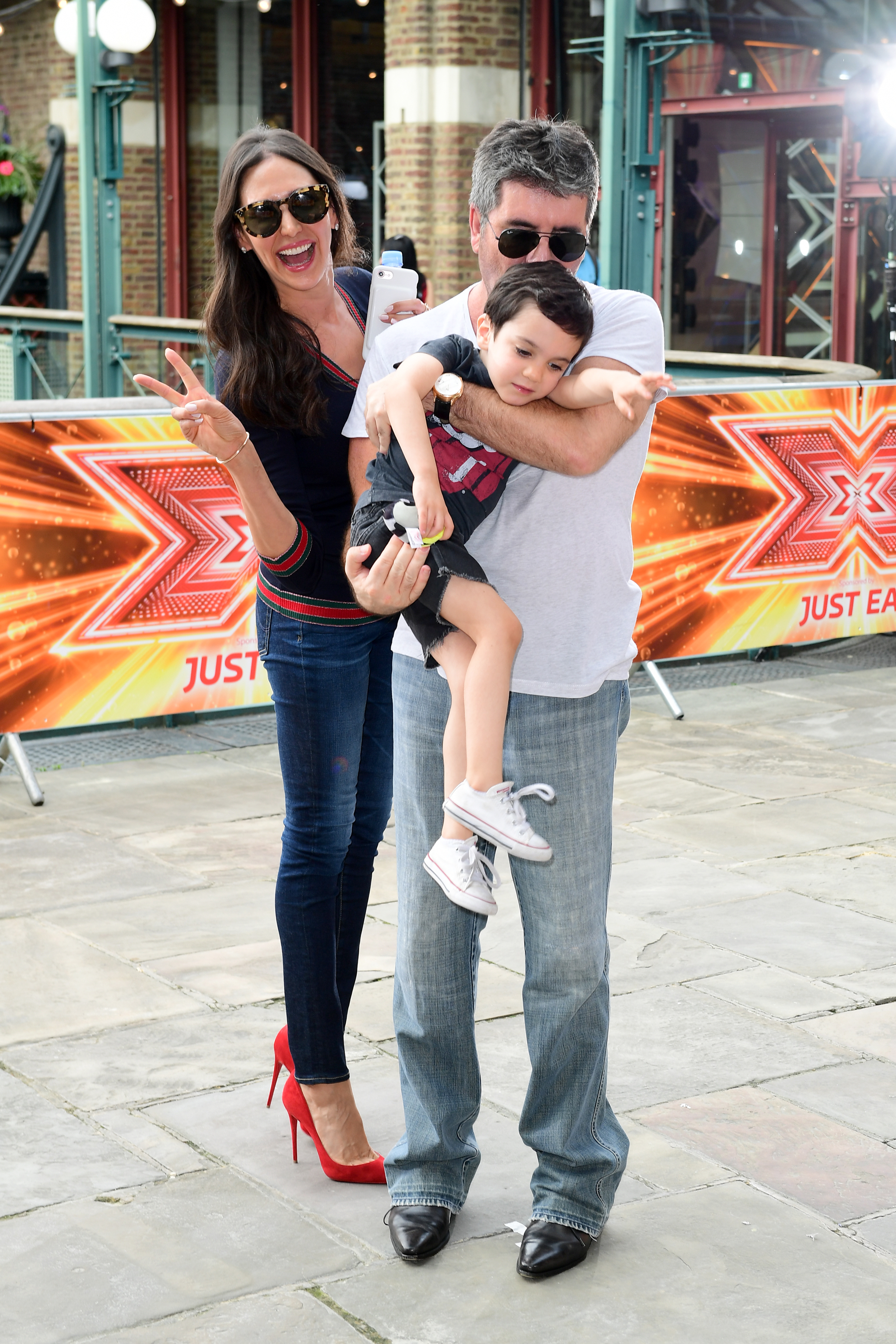 Lauren Silverman, Simon Cowell, and their son Eric Cowell at the "X Factor" filming in London on July 6, 2017 | Source: Getty Images