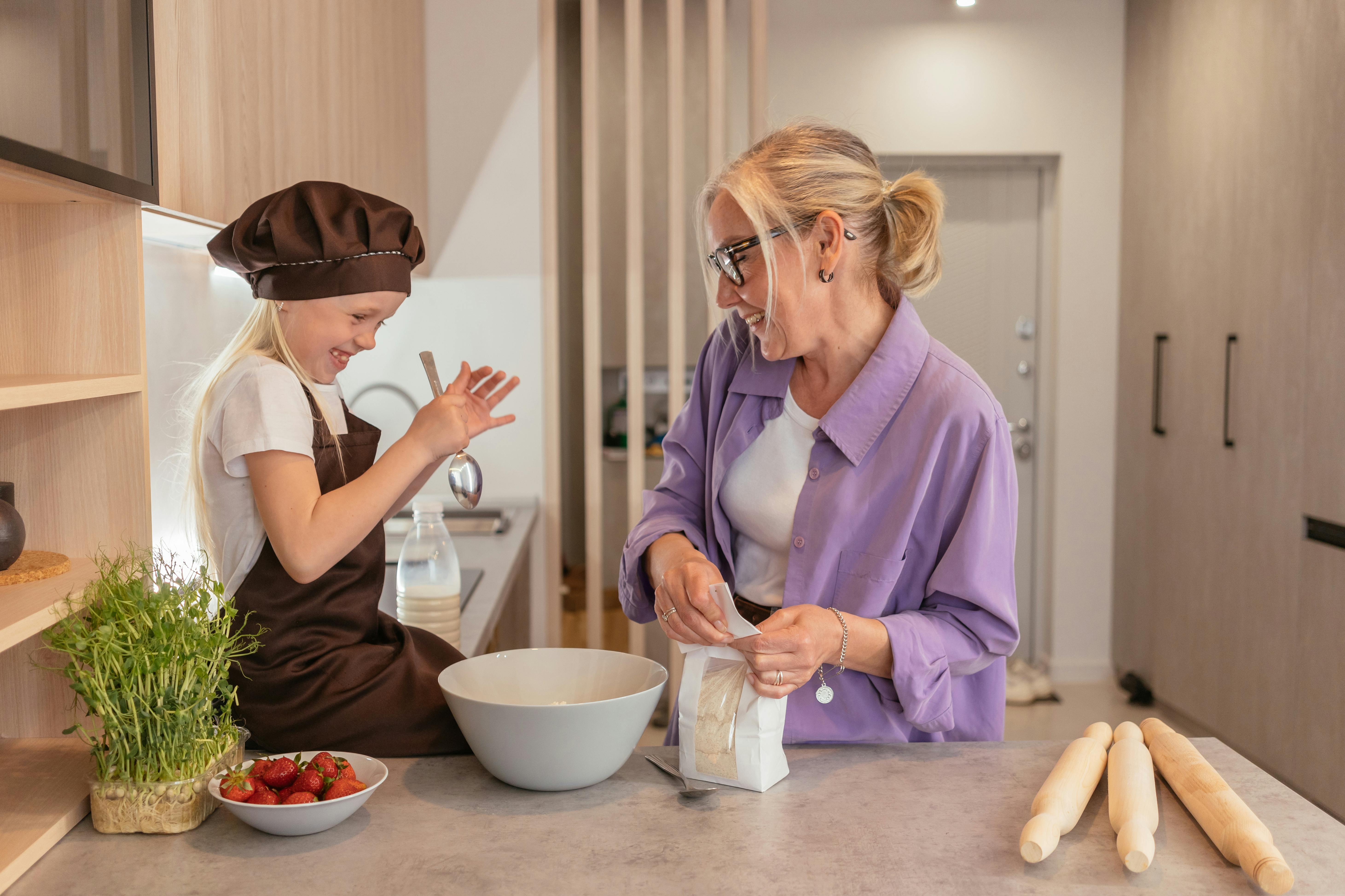 A woman cooking with her granddaughter | Source: Pexels
