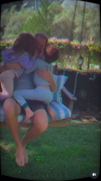 Lilibet and Archie bombarding their dad with hugs and kisses on a garden swing. | Source: Instagram/meghan