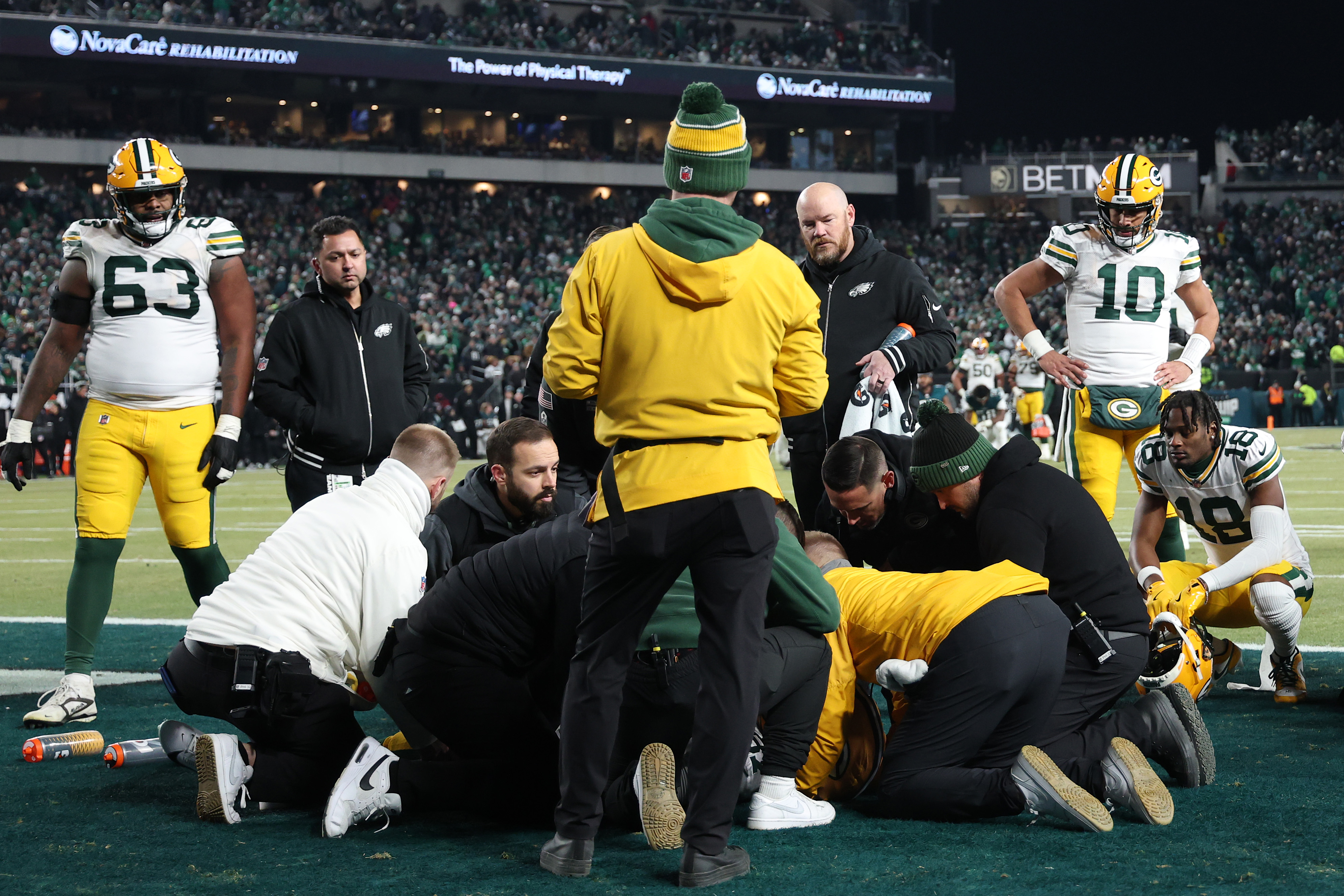 Romeo Doubs is treated for an injury during the NFC Wild Card Playoff on January 12, 2025. | Source: Getty Images