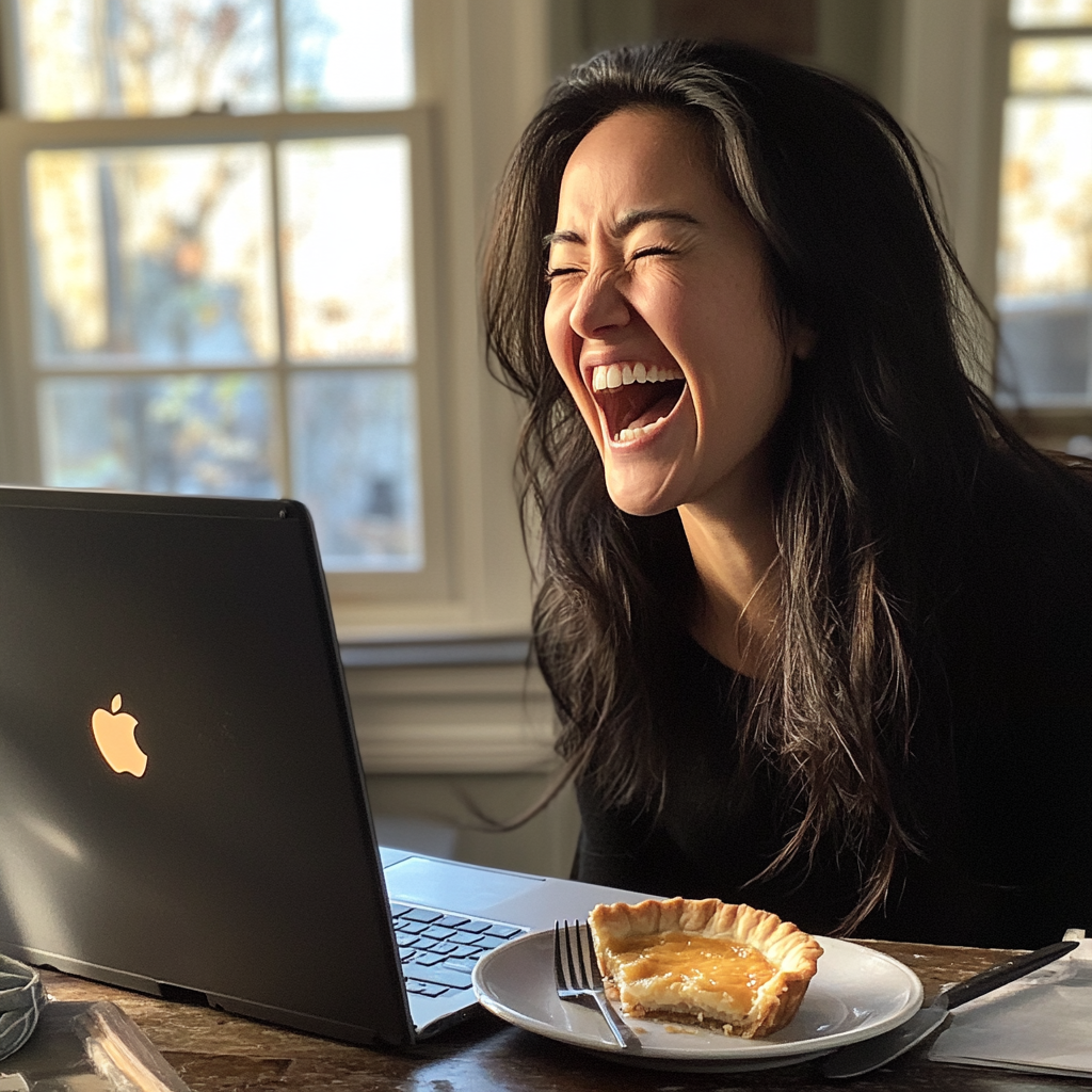 A woman laughing at her laptop screen | Source: Midjourney