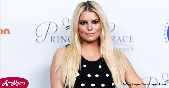 Jessica Simpson shares a cute photo with her hubby and two kids as they step out in the rain