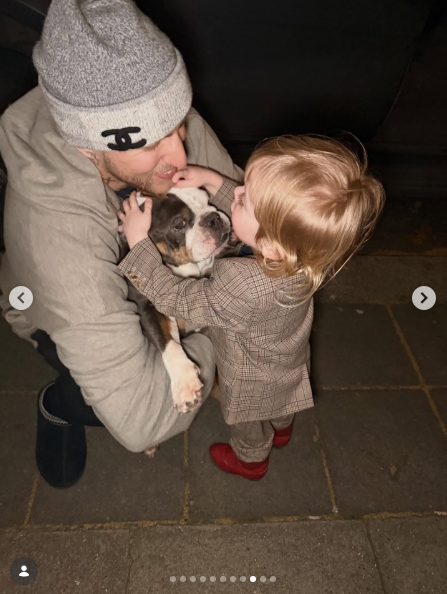 The group stepped outside into the evening, where Langford crouched down on the pavement to hold a small bulldog while Osbourne's son, dressed in his checked suit and bright red shoes, reached over to pet the animal. Langford pressed his face close to the dog's as the three-year-old looked on with great interest. | Source: Instagram/kellyosbourne