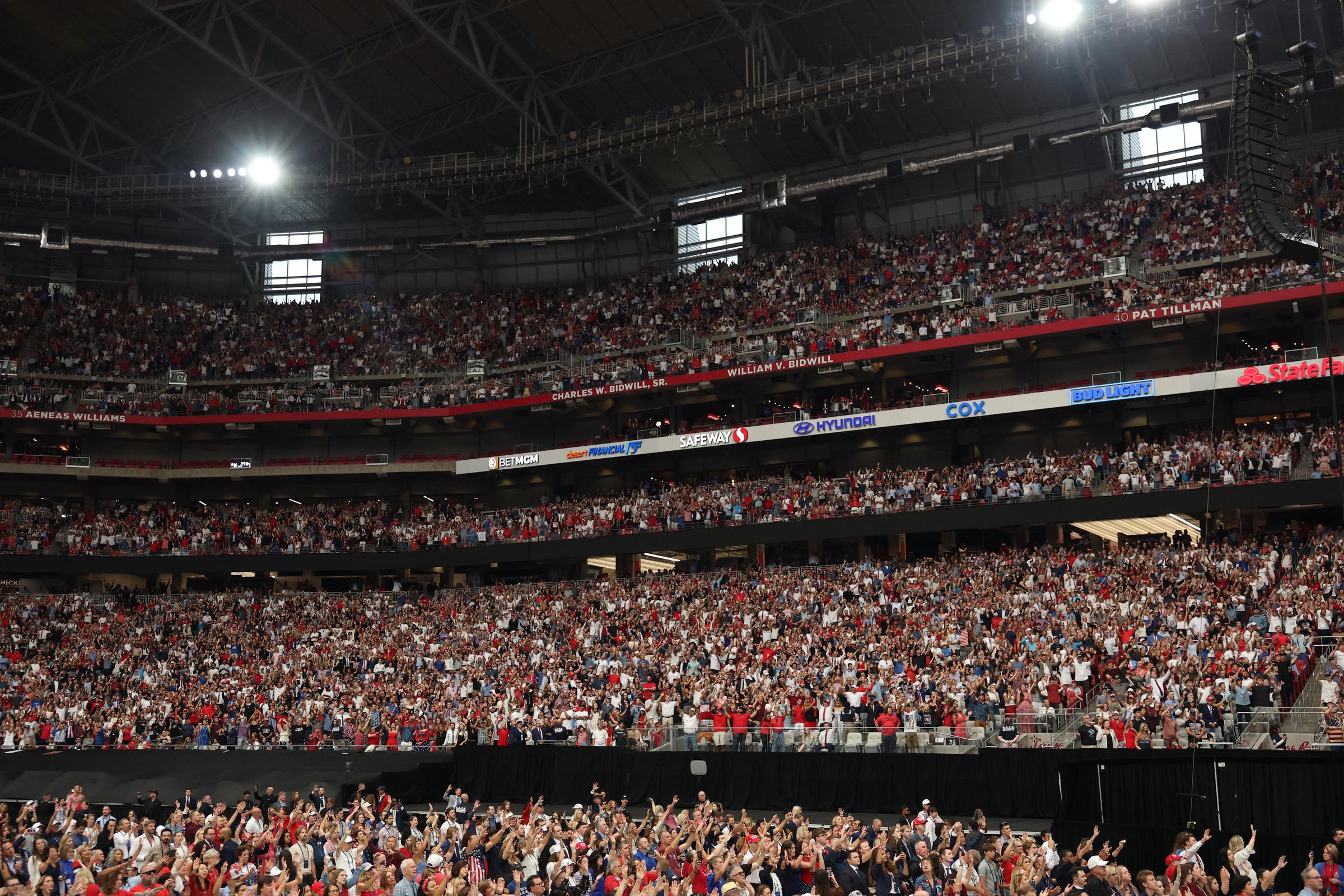 Attendees pray ahead of the public memorial service for Charlie Kirk at State Farm Stadium on September 21, 2025 | Source: Getty Images