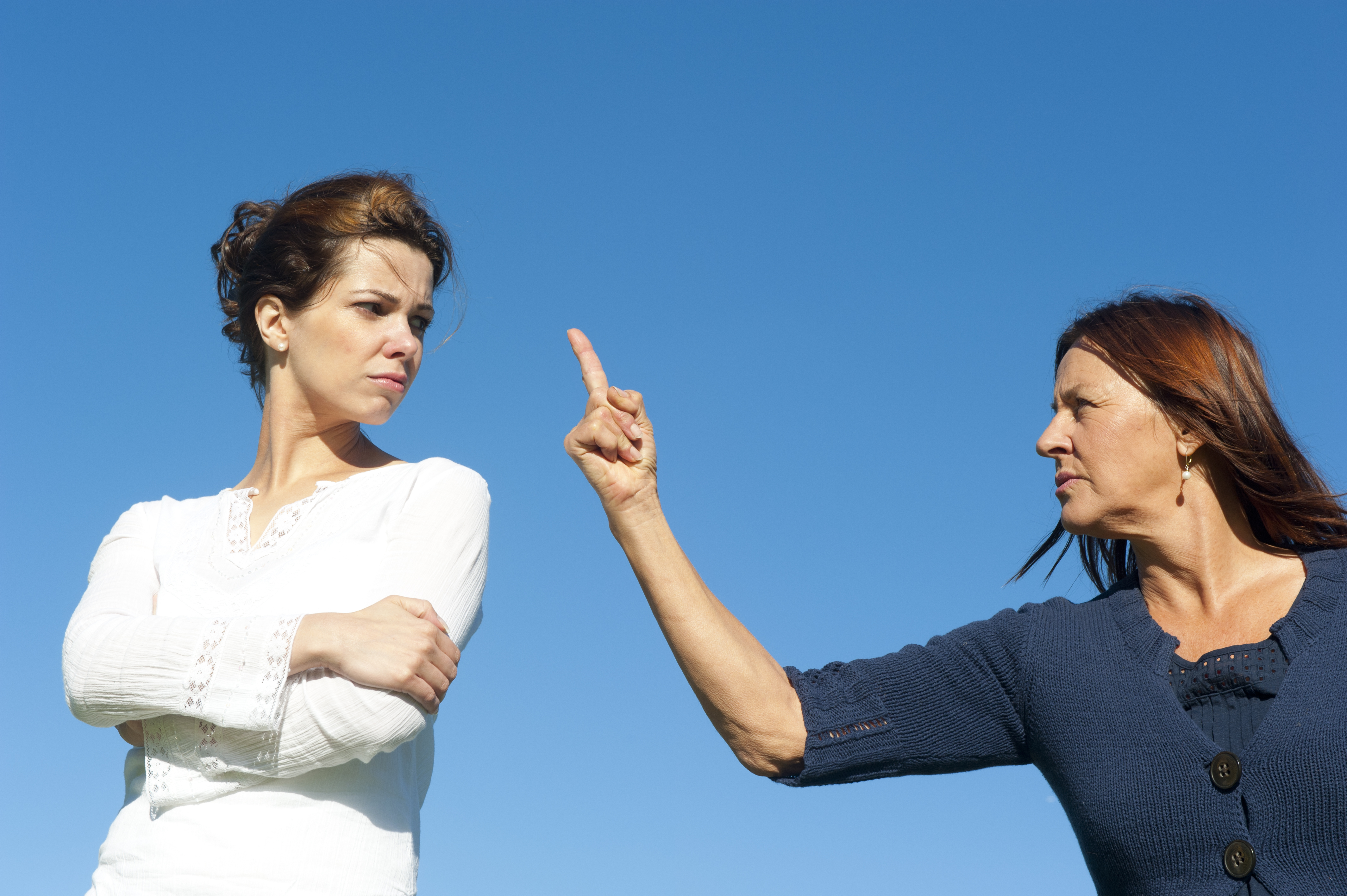 A woman angrily pointing her finger at another woman | Source: Shutterstock