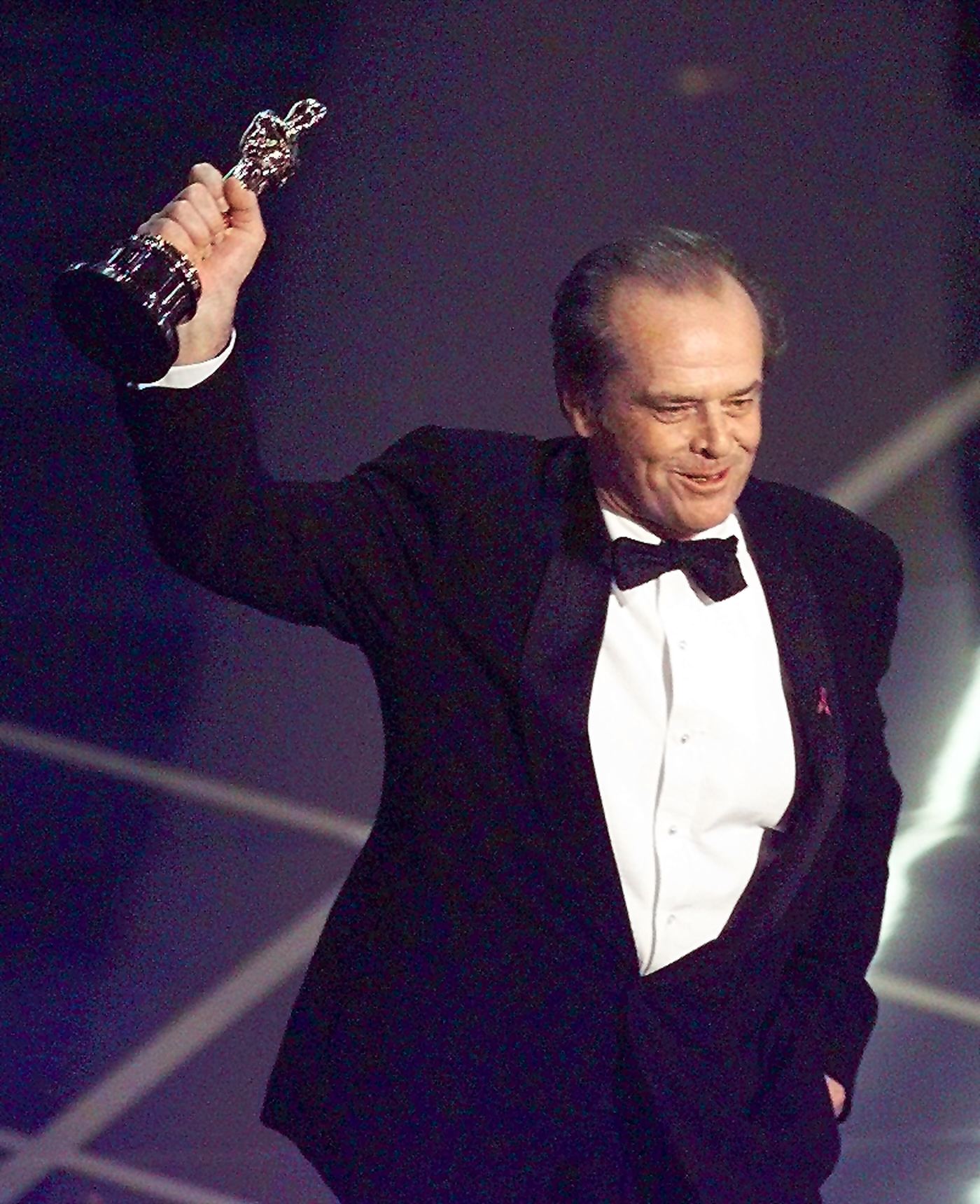 Jack Nicholson holds up his Oscar after winning the Best Actor in a Leading Role Category during the 70th Academy Awards at the Shrine Auditorium on March 23, 1998. | Source: Getty Images