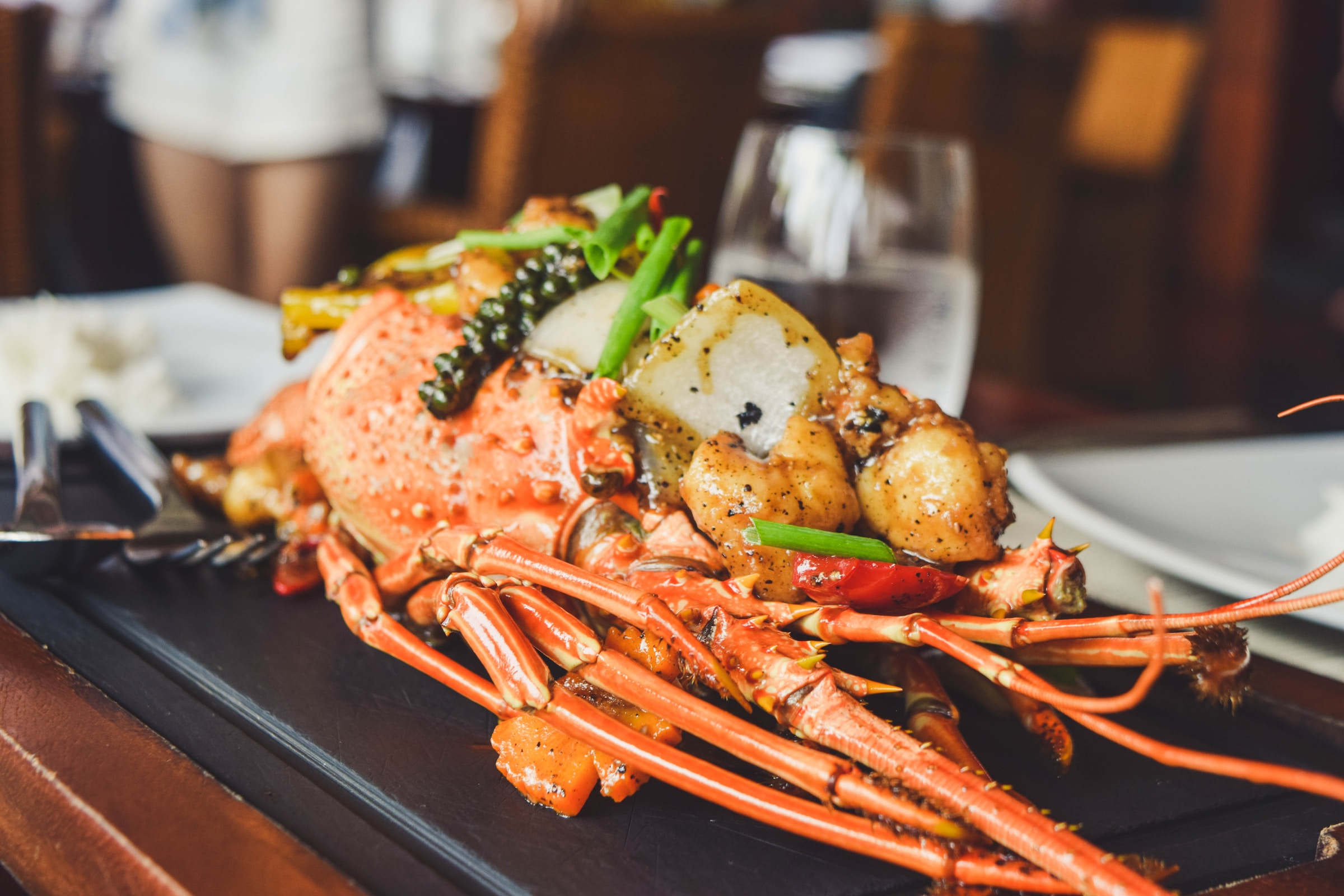 Lobster served on a black tray in a restaurant | Source: Unsplash