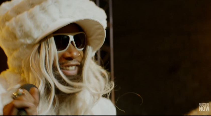 Wiz Khalifa portrays Parliament-Funkadelic founder George Clinton in a scene from the trailer for "Spinning Gold," shared in a video published on December 15, 2022. | Source: YouTube/E! News