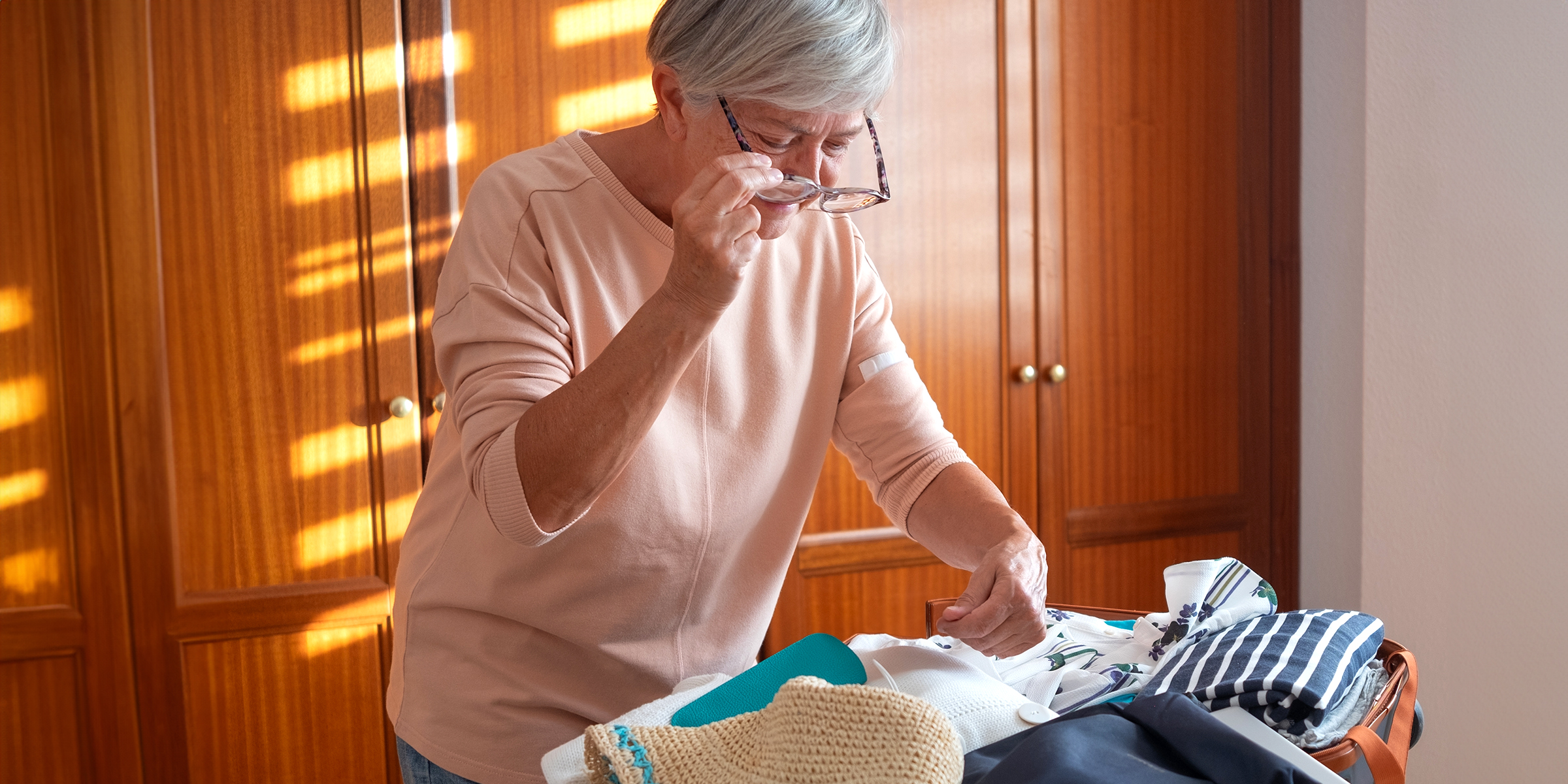 An older woman assembling old clothes | Source: Shutterstock