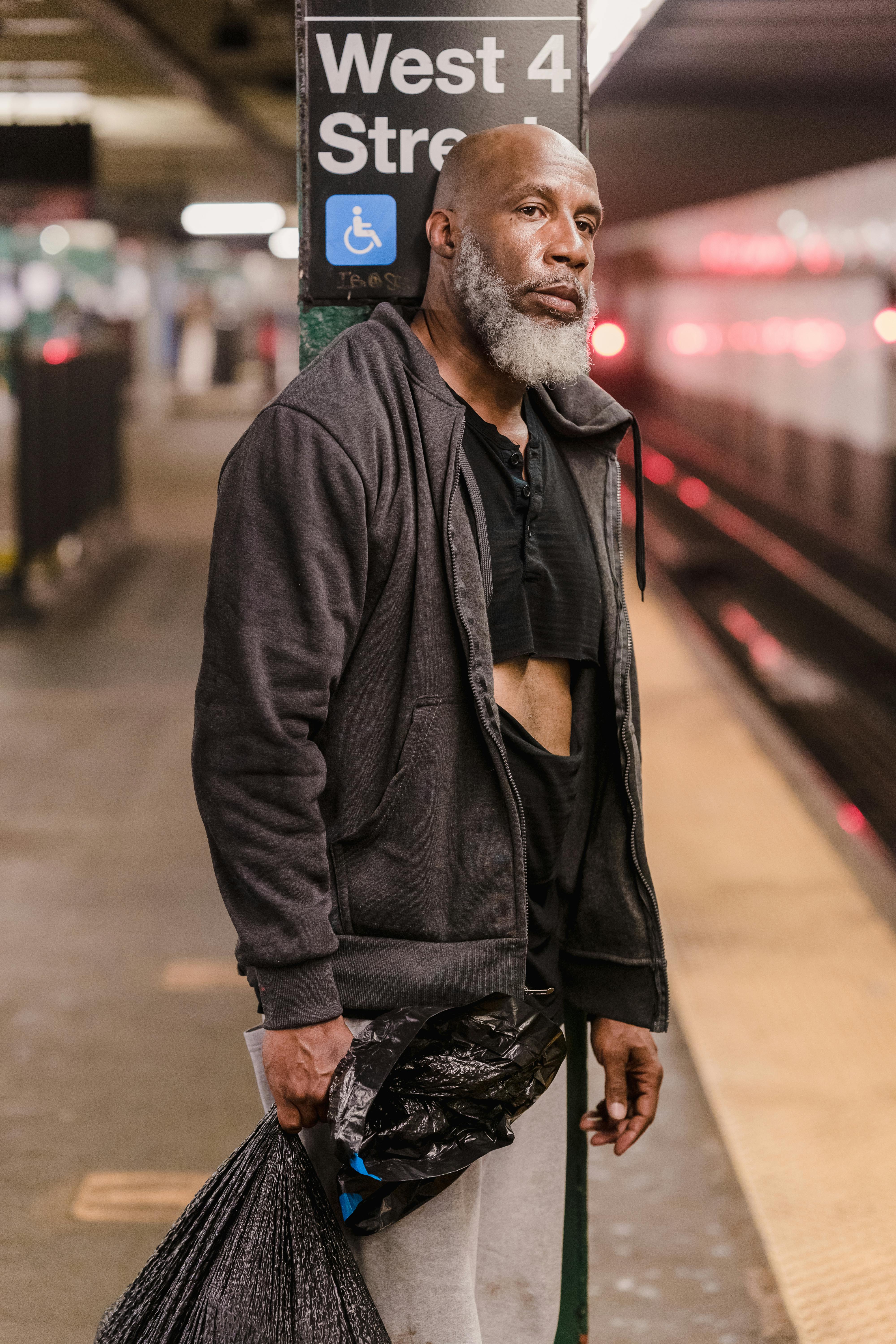 Man in black jacket standing near sidewalk | Source: Pexels