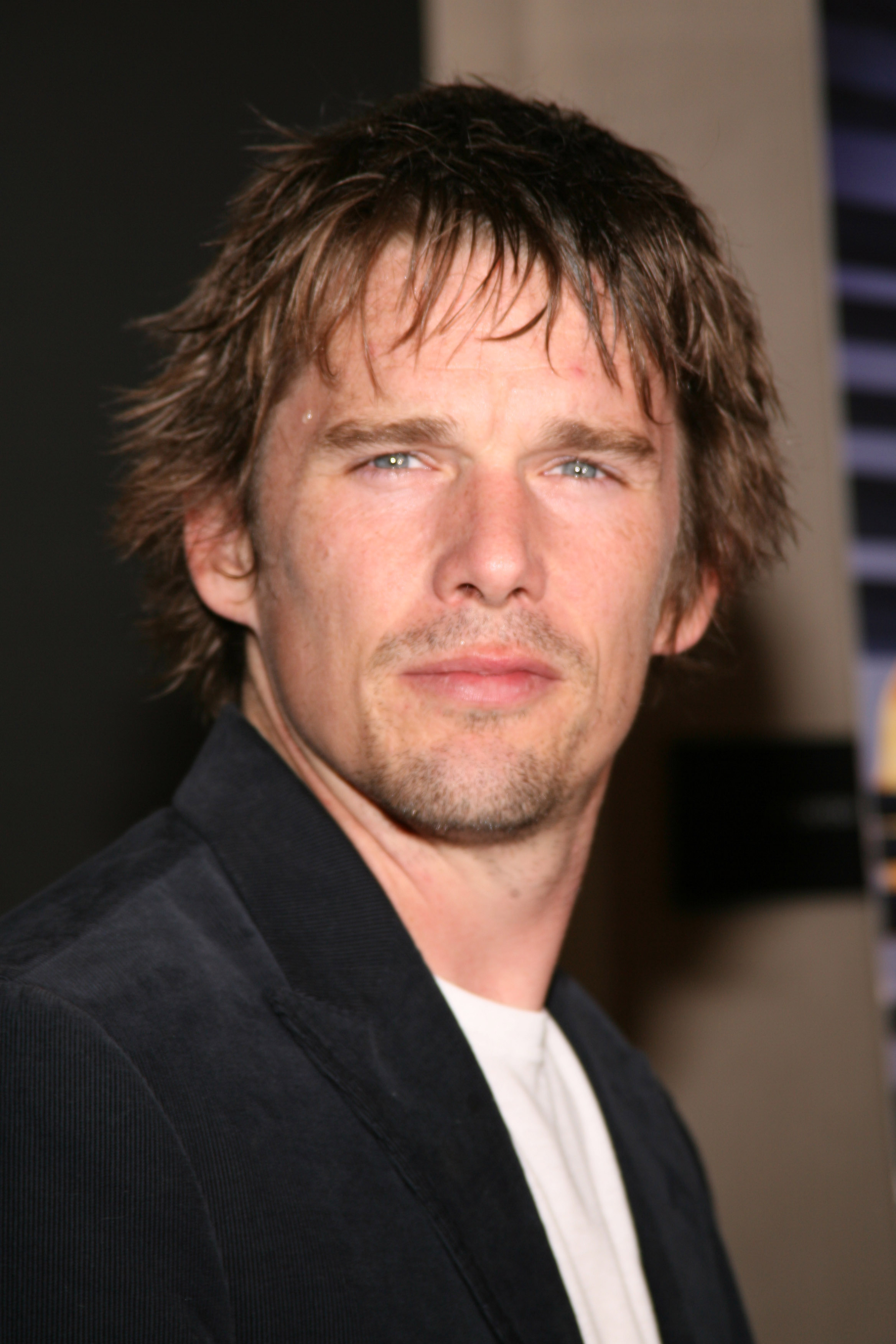 Ethan Hawke attended a special screening of "A Scanner Darkly" on July 5, 2006, in New York, United States, wearing a dark blazer over a simple white T-shirt as he posed with tousled hair and a light goatee — a distinctly mid-2000s look that captured his brooding screen persona and cemented his long-standing Hollywood presence.