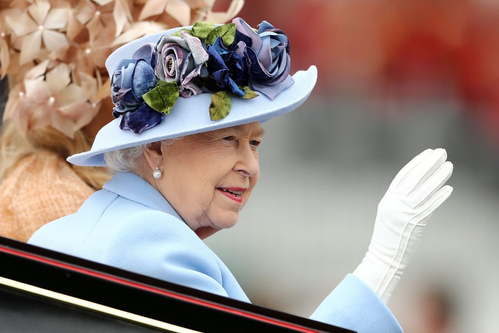 Queen Elizabeth II waves to the crowds as she arrives on day one of Royal Ascot at Ascot Racecourse | Photo: Getty Images