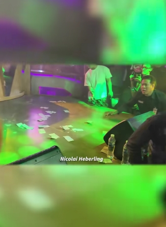 Bills are seen scattered across the stage after the rapper instructed staff to collect the money and return it to the fan. | Source: TikTok/tmz