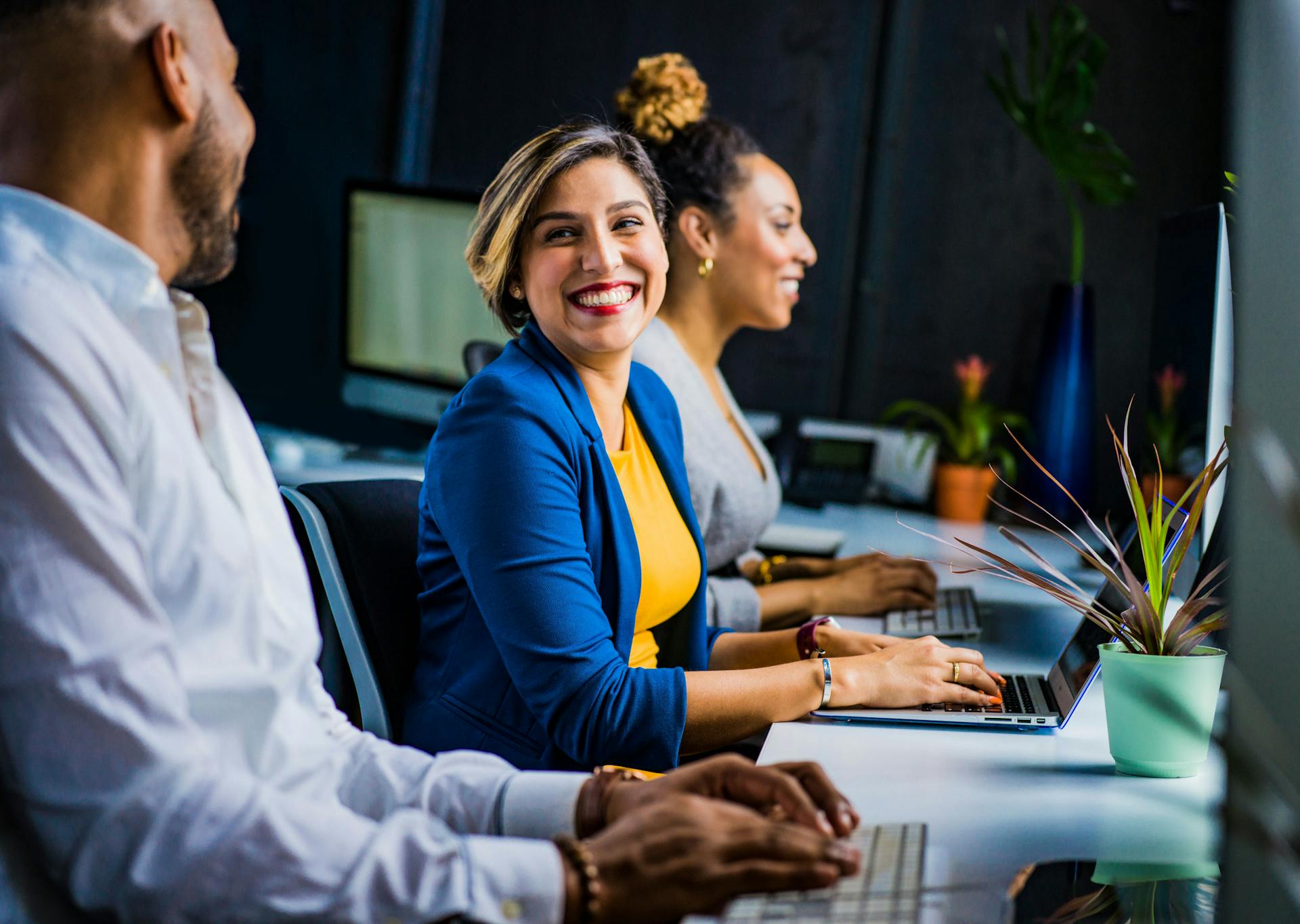 A woman smiling at her colleague | Source: Pexels