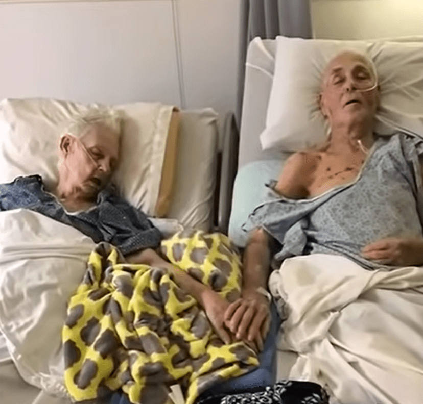 Tom and Delma Ledbetter lying in hospital together while holding hands.┃Source: youtube.com/KPRC 2 Click2Houston