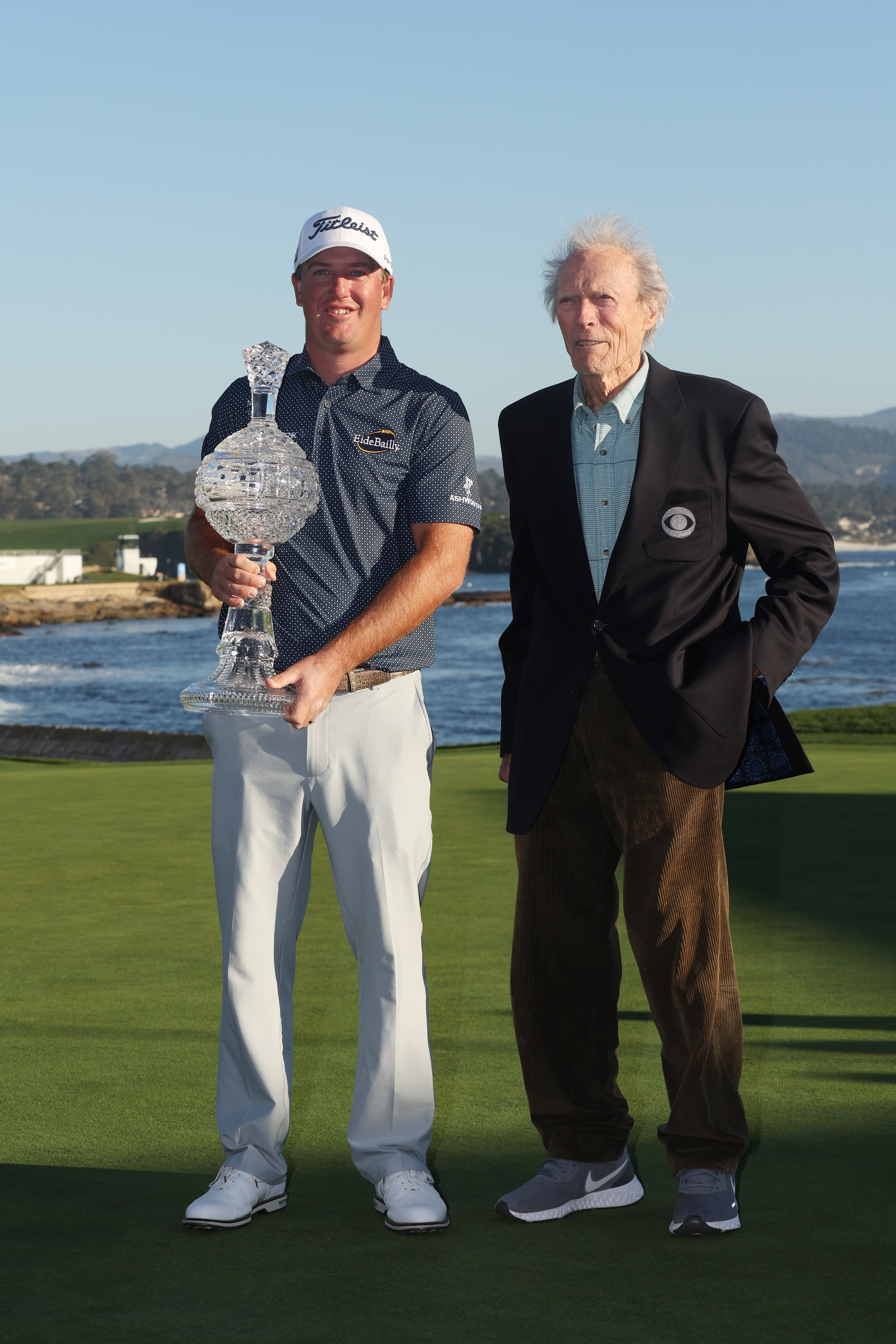 Clint Eastwood poses with Tom Hoge who won the final round of the AT&T Pebble Beach Pro-Am at Pebble Beach Golf Links on February 6, 2022, in Pebble Beach, California. | Source: Getty Images