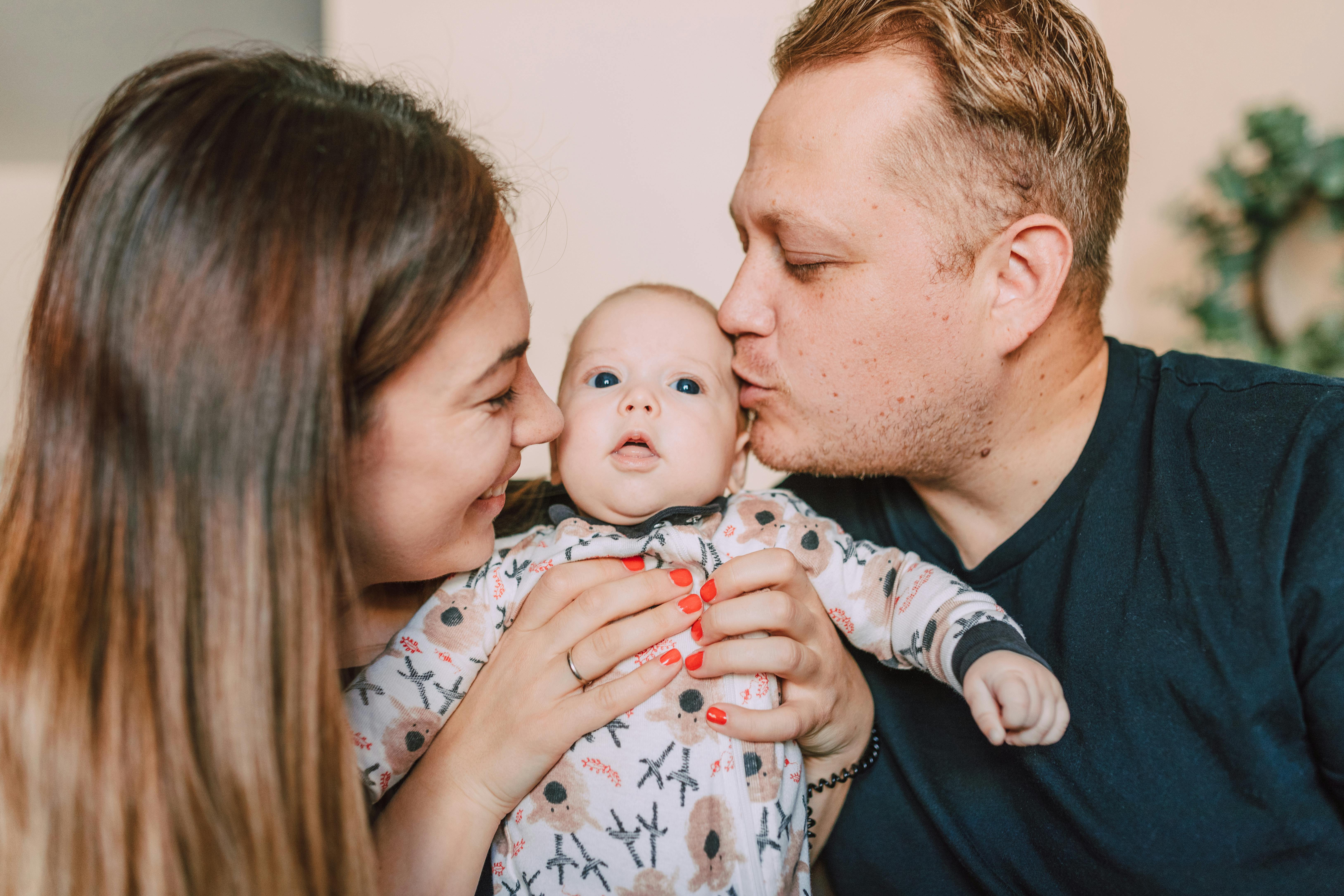 A couple gushing over their newborn baby | Source: Pexels