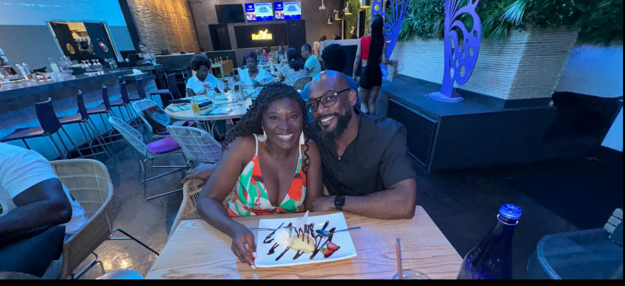 Nancy Metayer Bowen and her husband, Stephen Bowen, lean in close at a softly lit restaurant table, smiling warmly over a plated dessert, capturing an intimate, relaxed date-night moment amid a lively dining backdrop. | Source: Facebook/Nancy Metayer Bowen