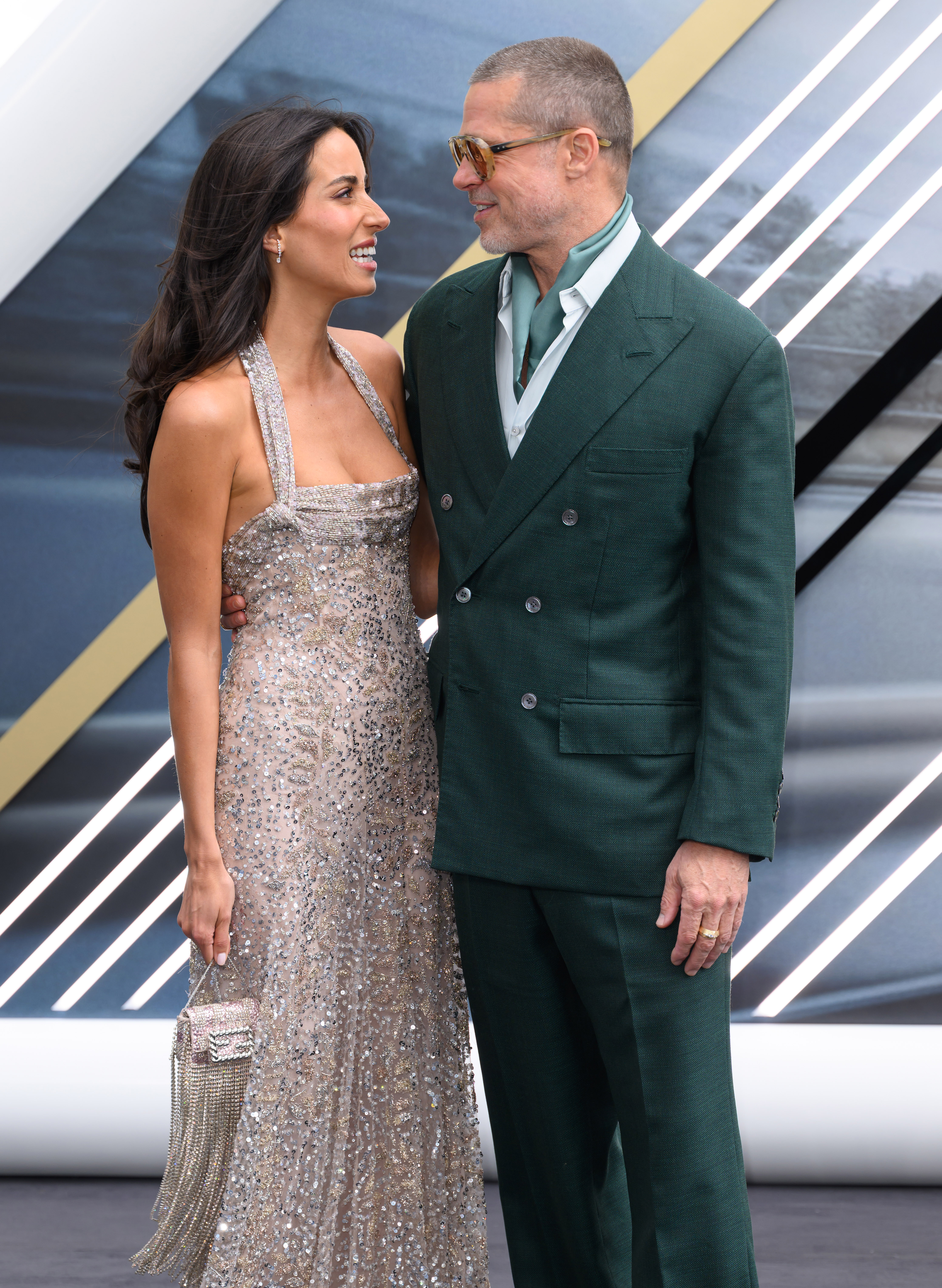 Ines de Ramon and Brad Pitt share a smile and pose arm-in-arm on the red carpet at the "F1: The Movie" premiere in London, on June 23, 2025 | Source: Getty Images