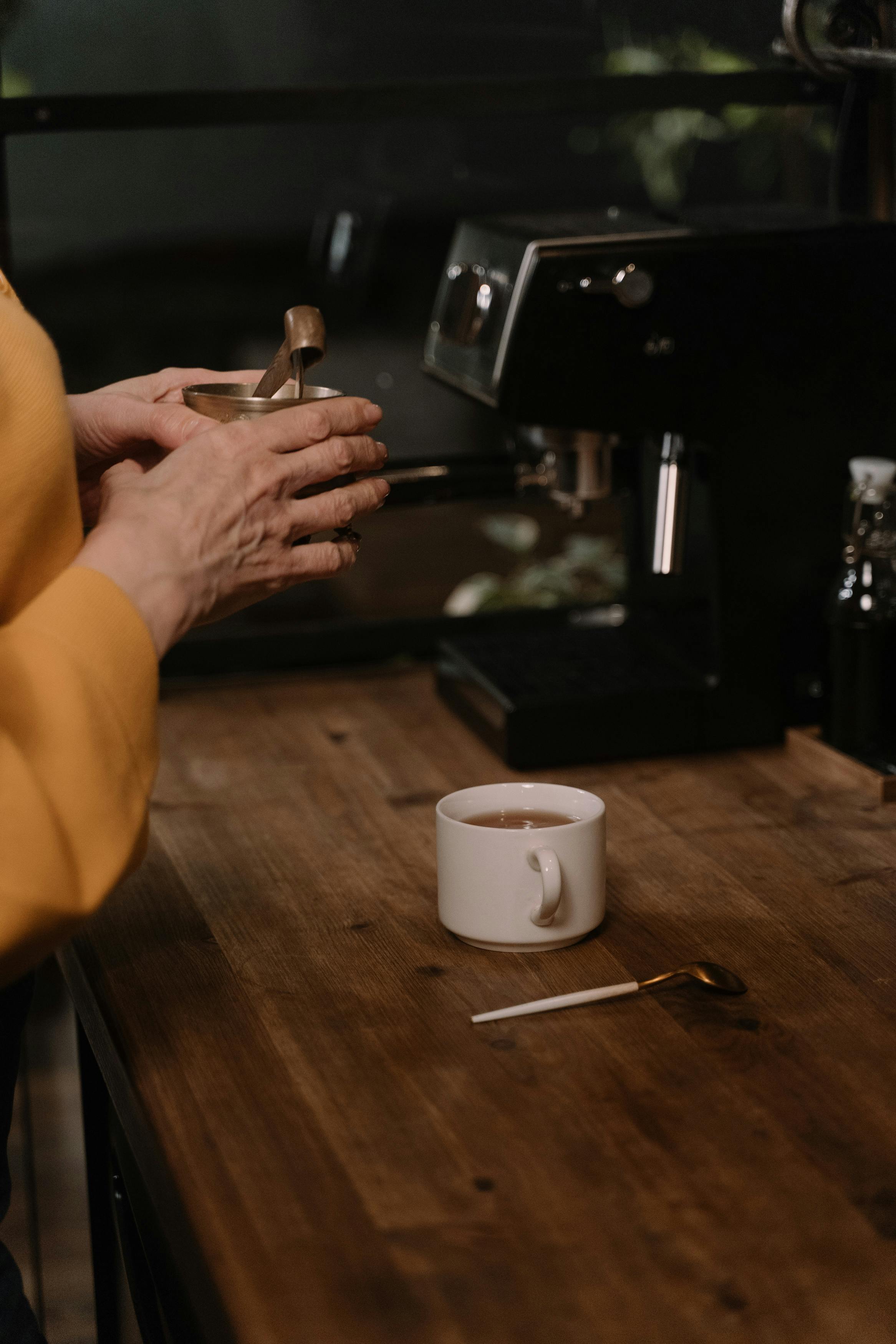 A woman making coffee | Source: Pexels
