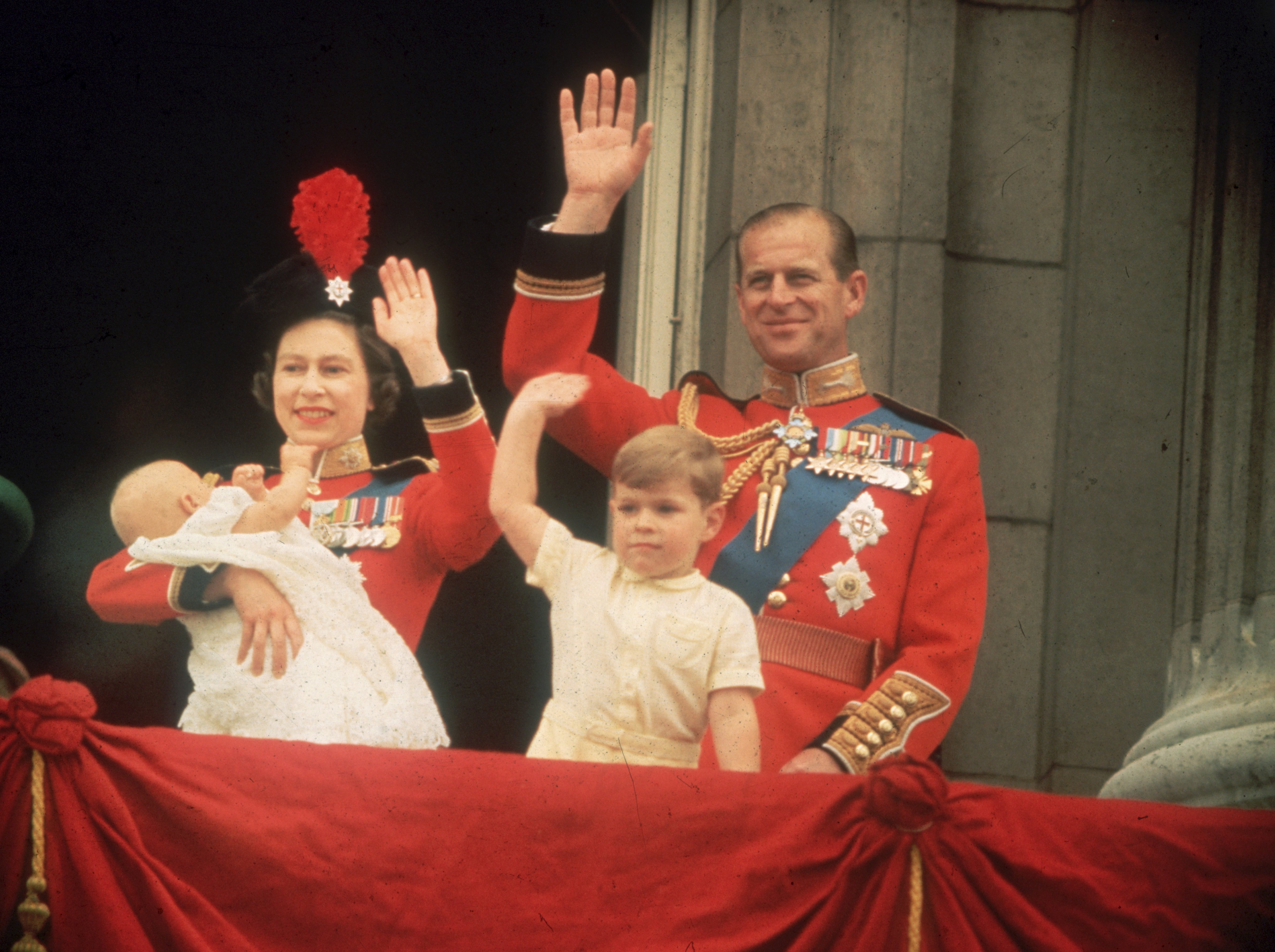 Queen Elizabeth, Prince Philip, Prince Andrew and Prince Edward waving to the crowds from the balcony at Buckingham Palace, during the Trooping of the Colour. | Source: Fox Photos/Getty Images