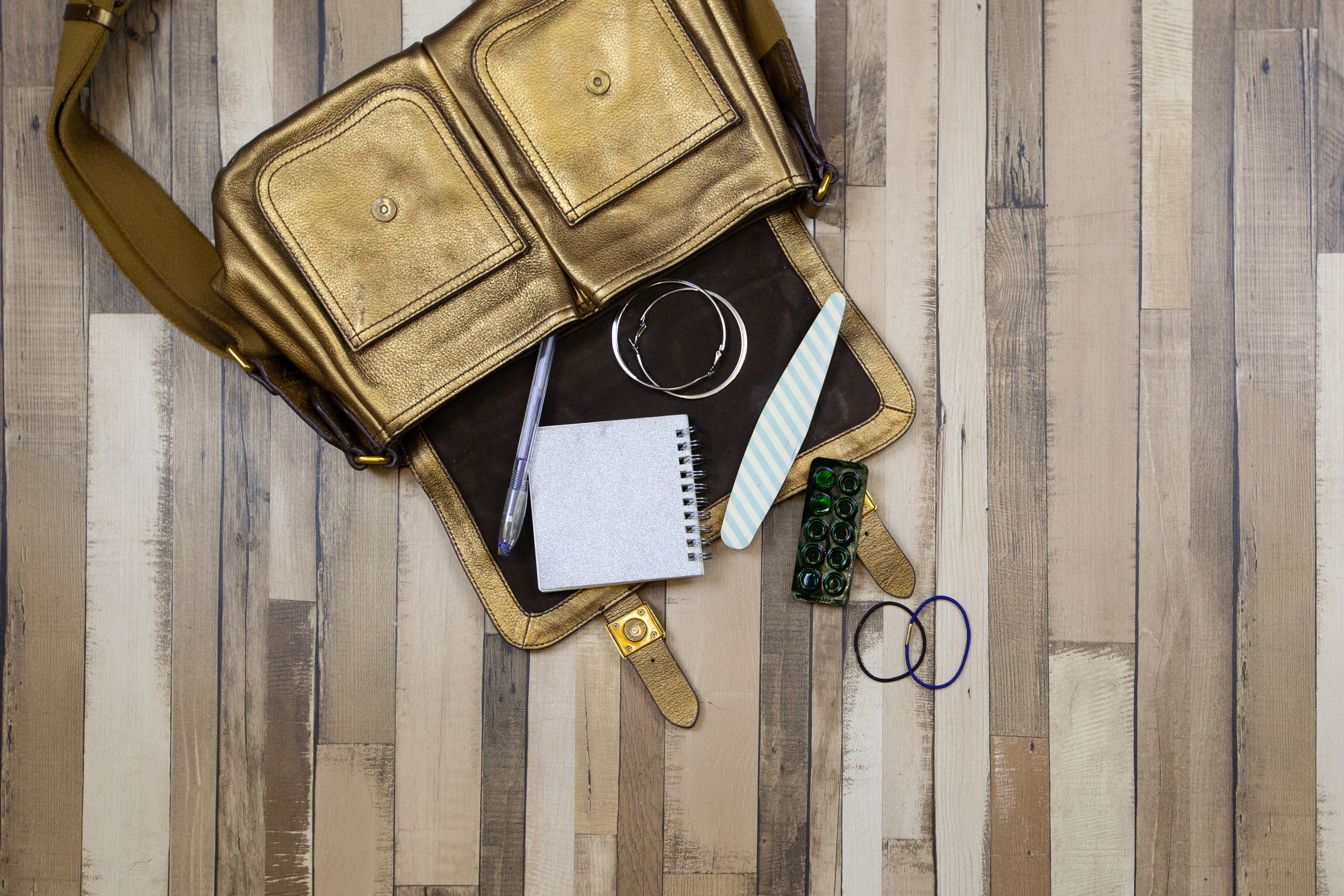 The golden bag fell to the wooden floor | Source: Shutterstock