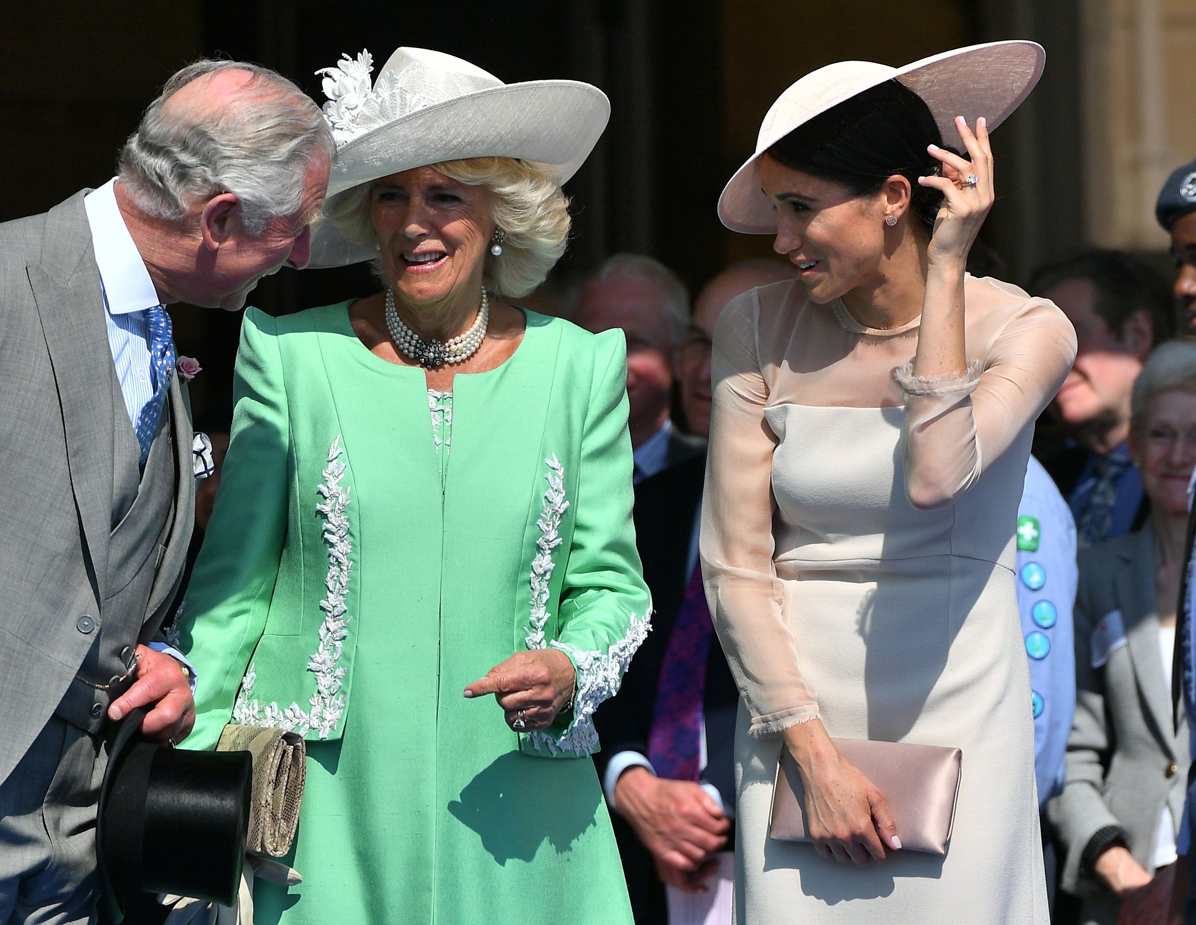 Prince Charles, Duchess Camilla and Duchess Meghan at Charles' 70th Birthday Garden Party at Buckingham Palace in London on May 22, 2018. |  Source: Getty Images