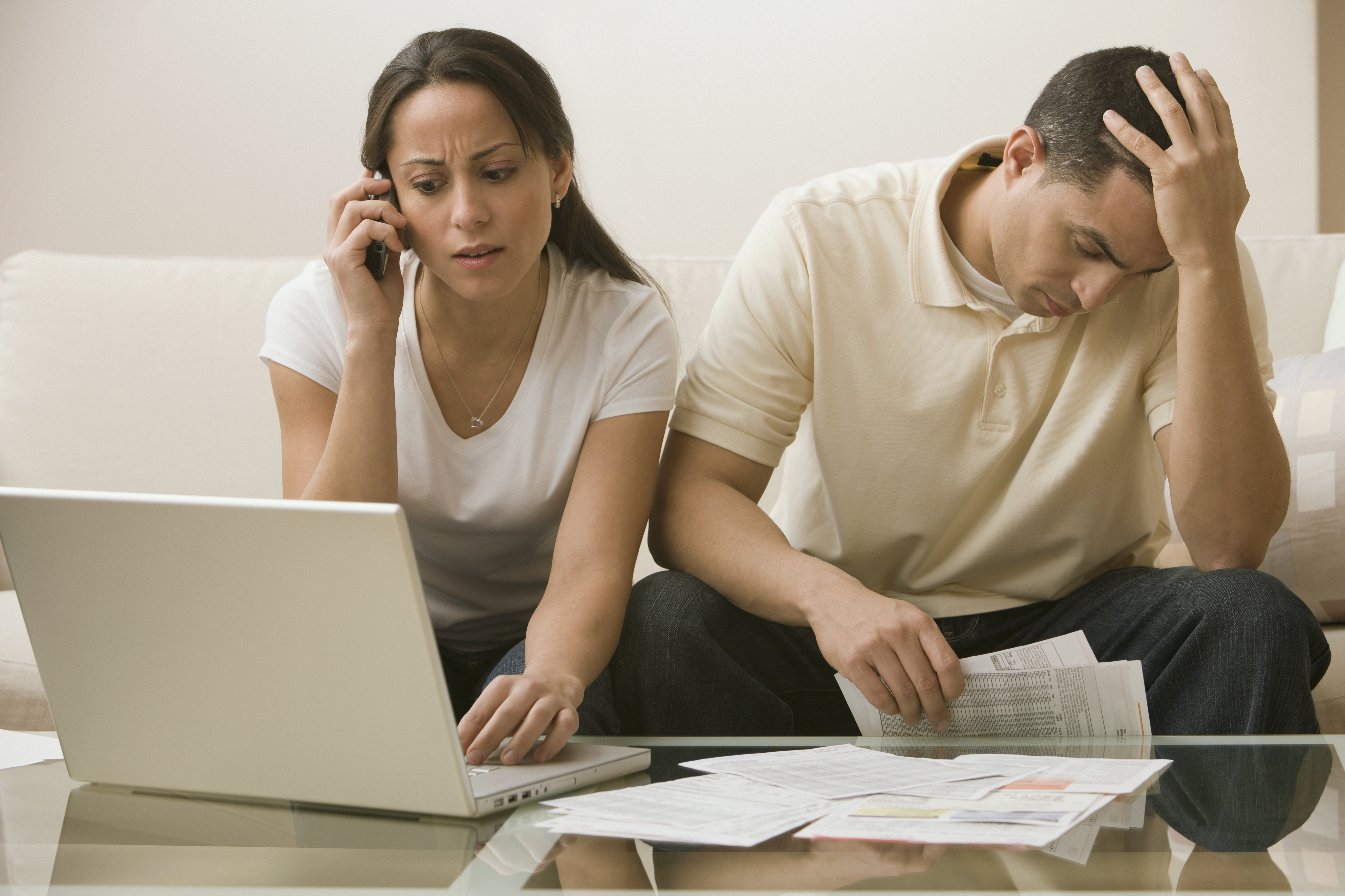 Hispanic couple having difficulty paying bills online | Source: Getty Images