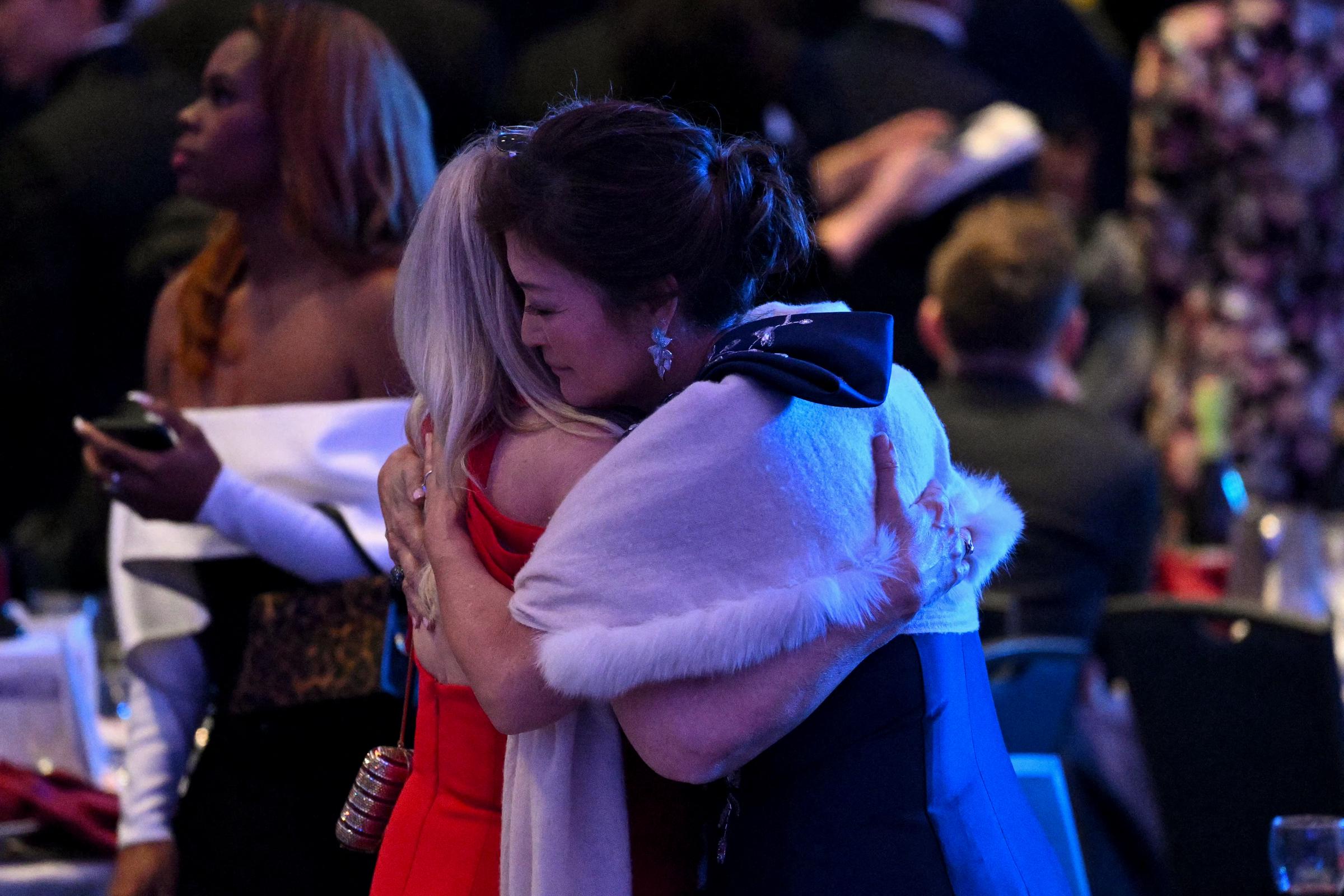 Attendees embrace inside the ballroom after shots were reportedly fired during the White House Correspondents' Dinner at Washington Hilton on April 25, 2026, in Washington, DC | Source: Getty Images