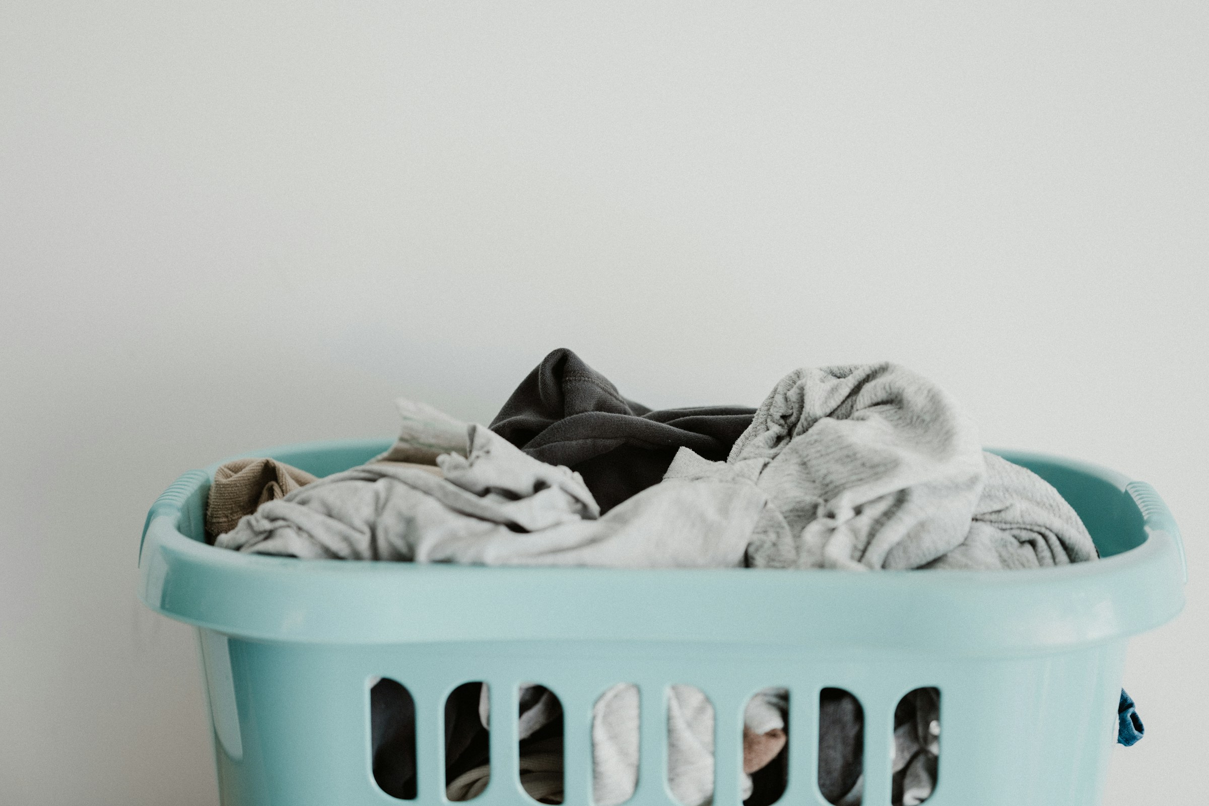 Clothes in a laundry basket | Source: Unsplash