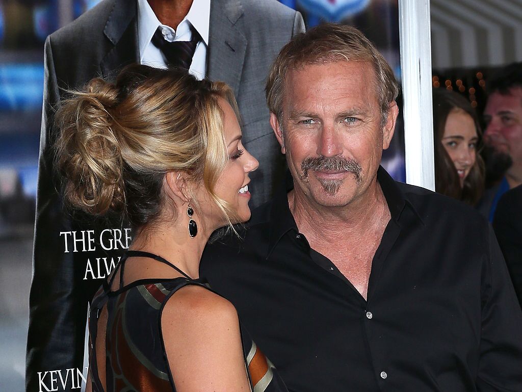 Kevin Costner and wife Christine Baumgartner at the premiere of "Draft Day" in  2014 | Source: Getty Images