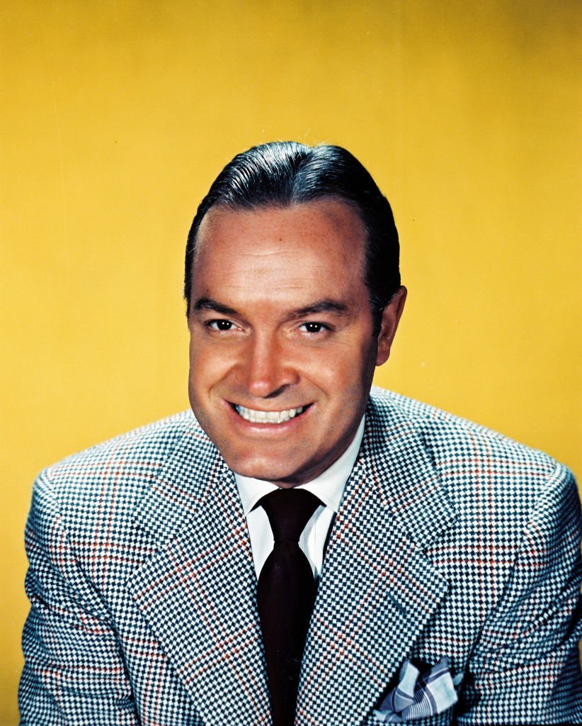 Bob Hope smiled in a studio portrait, against a yellow background on January 01, 1950 | Photo: Getty Images