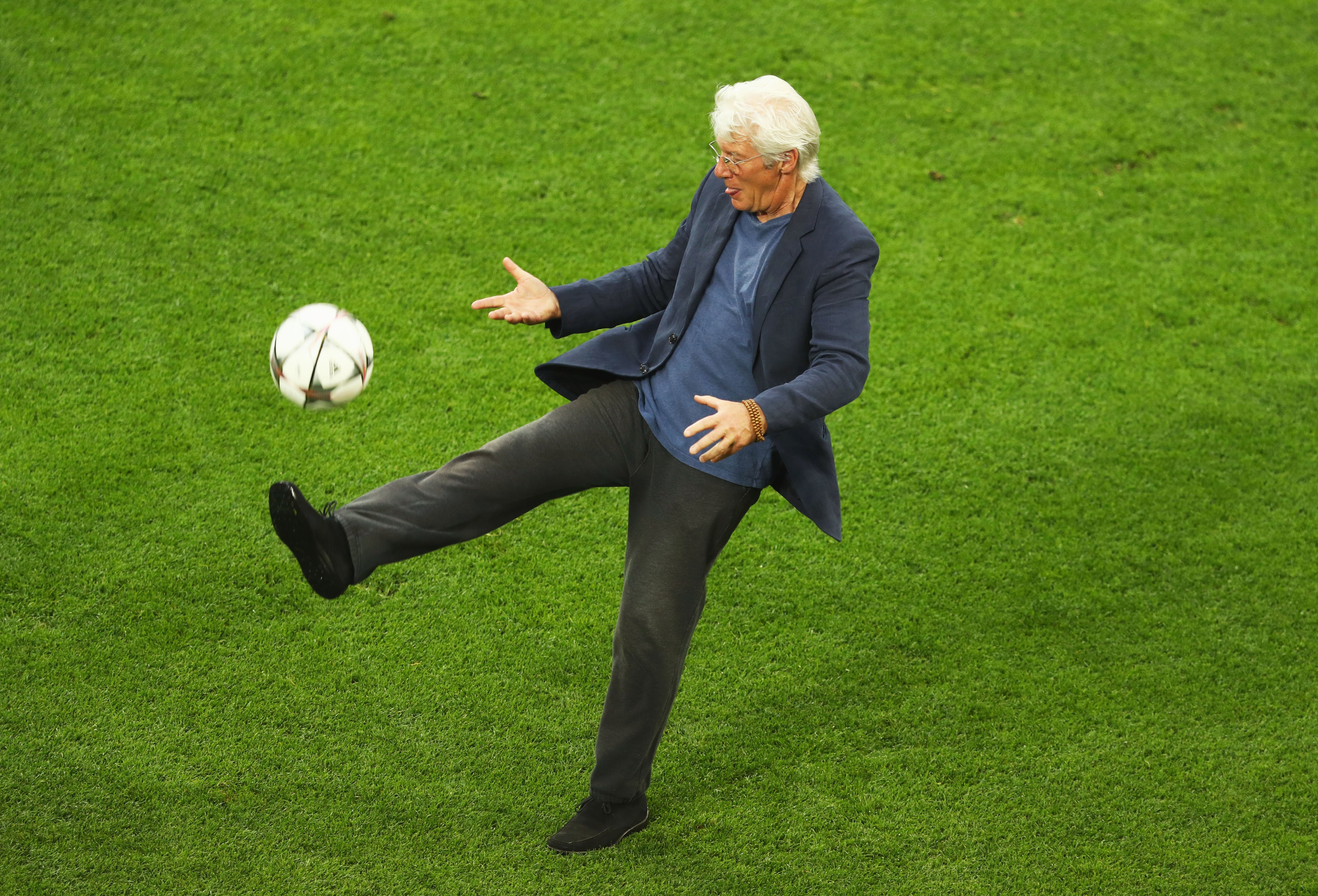 Richard Gere kicks the ball on the San Siro pitch after a Real Madrid training session on the eve of the UEFA Champions League Final against Atletico de Madrid at Stadio Giuseppe Meazza on May 27, 2016 in Milan, Italy | Source: Getty Images 