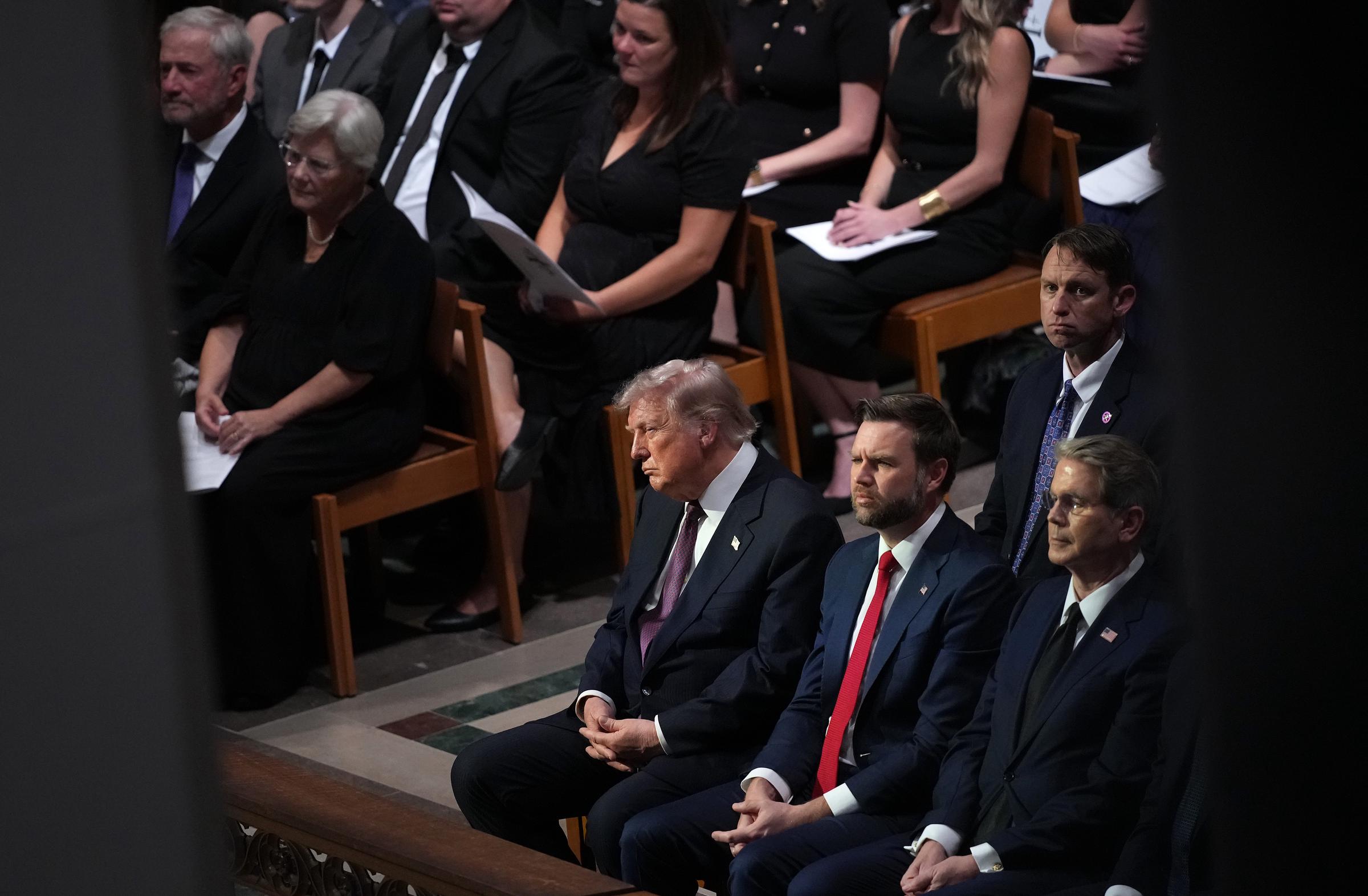Cameras continued to follow President Donald Trump as the funeral service progressed. Clips from this portion of the ceremony later fueled online debate over his demeanor. | Source: Getty Images