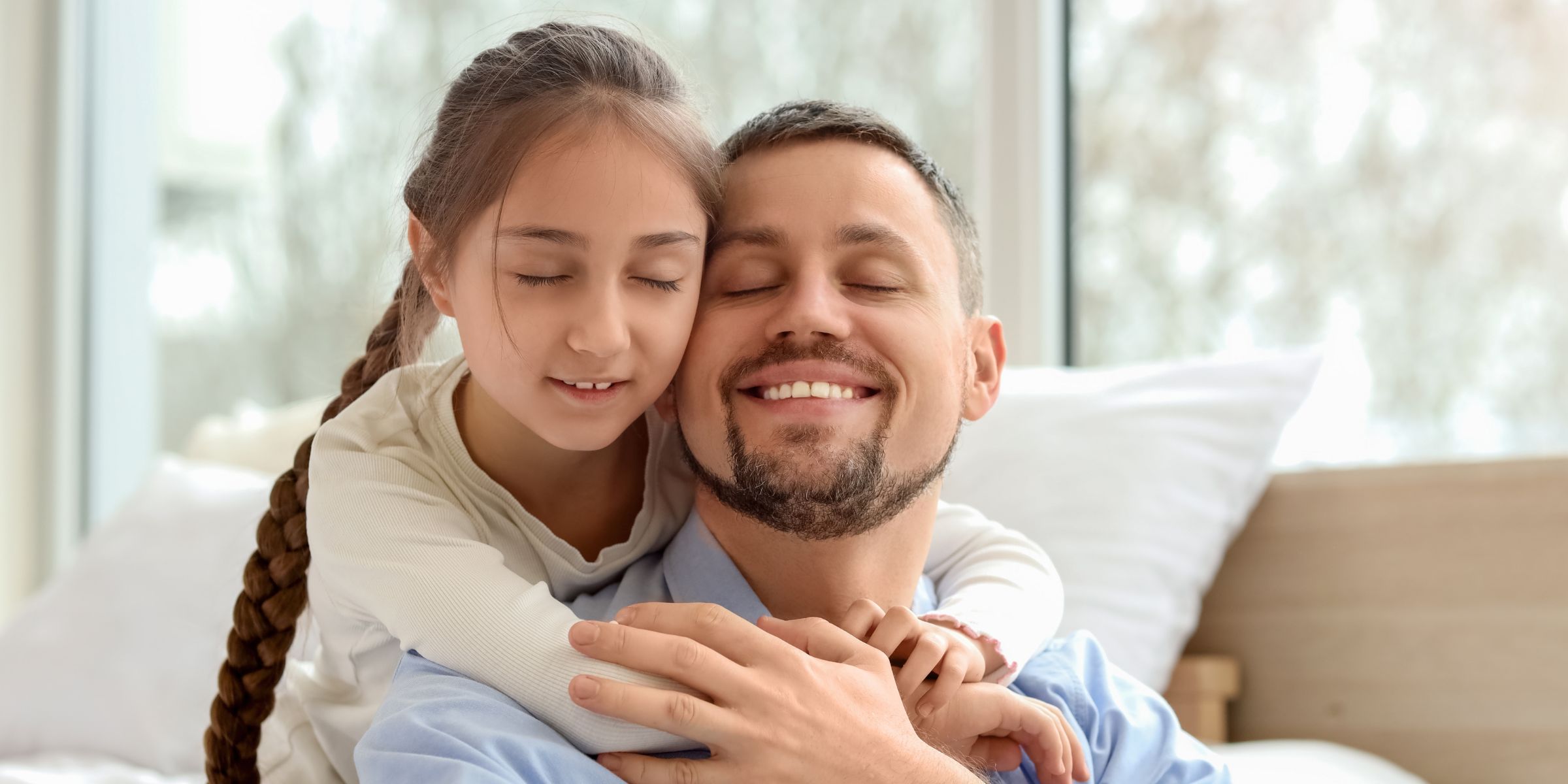 A girl hugging her father | Source: Shutterstock
