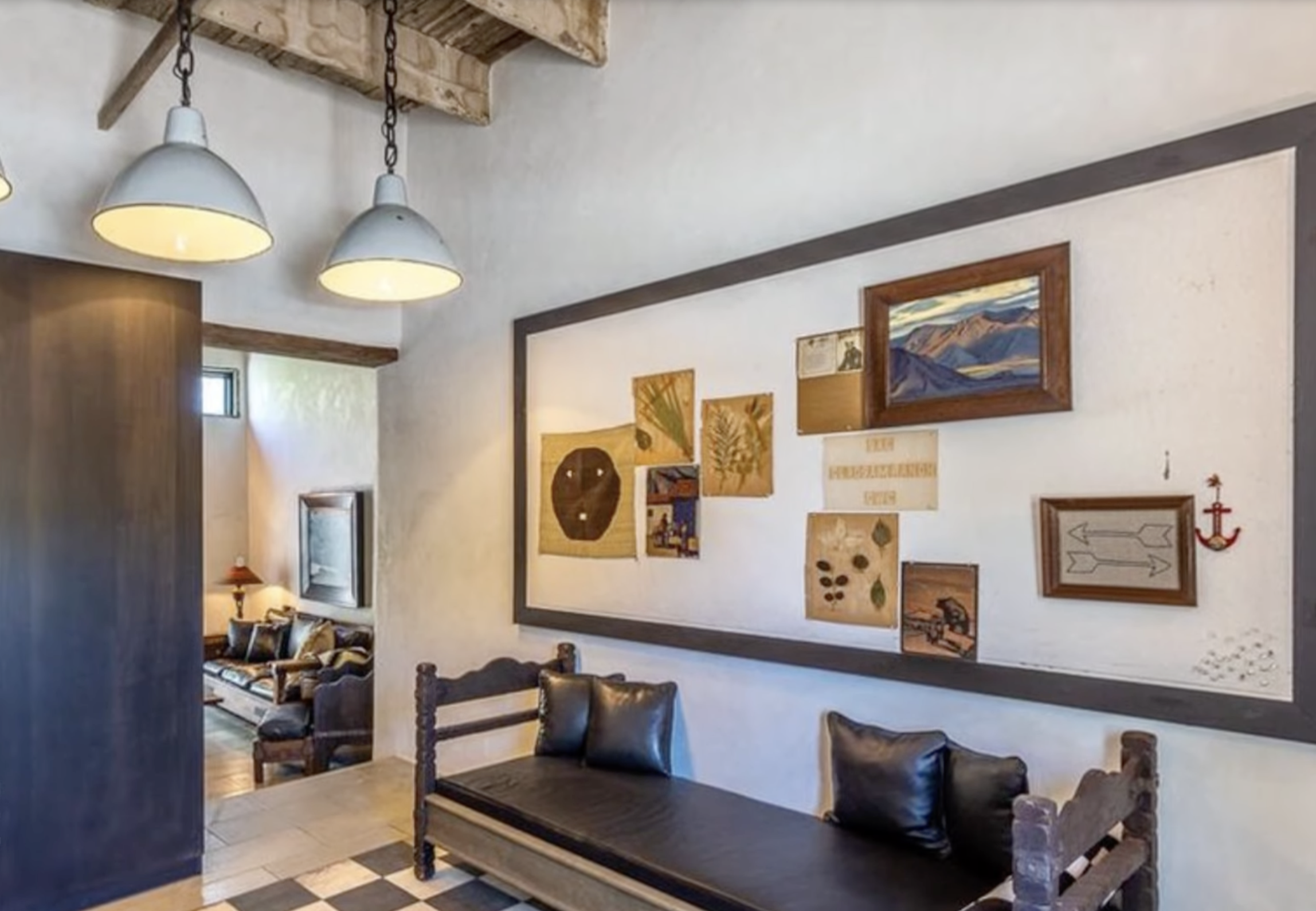 Eclectic wall collage and bench seating area inside Diane Keaton’s Sullivan Canyon home, dated February 3, 2022 | Source: YouTube/@FamousEntertainment500k
