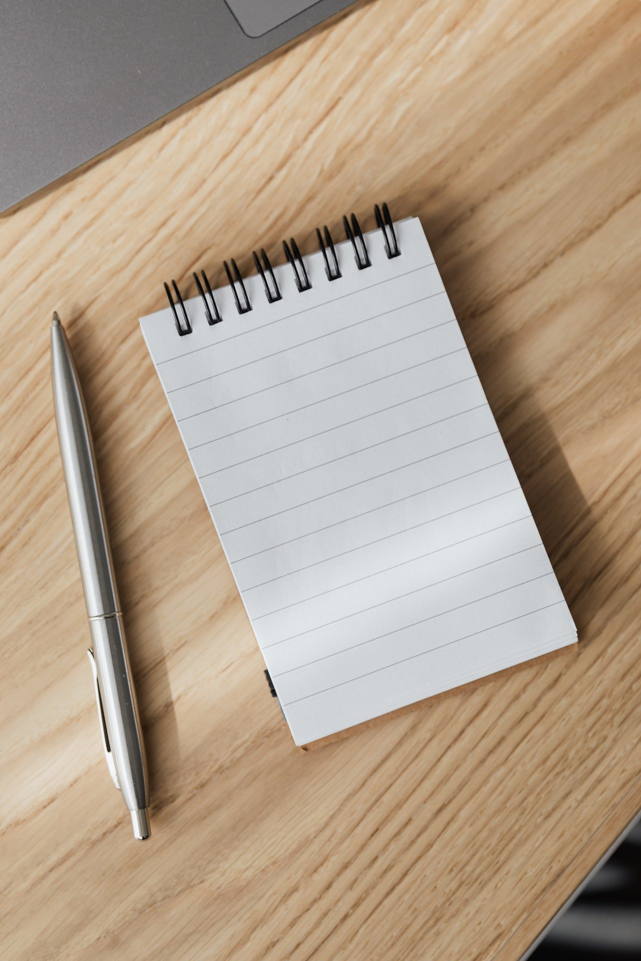 Notebook with a silver pen | Source: Pexels