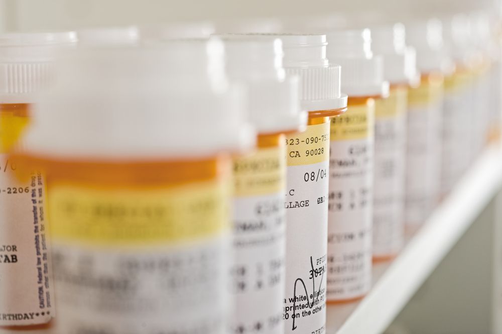 Bottles of pills lined up in a row. | Source: Shutterstock