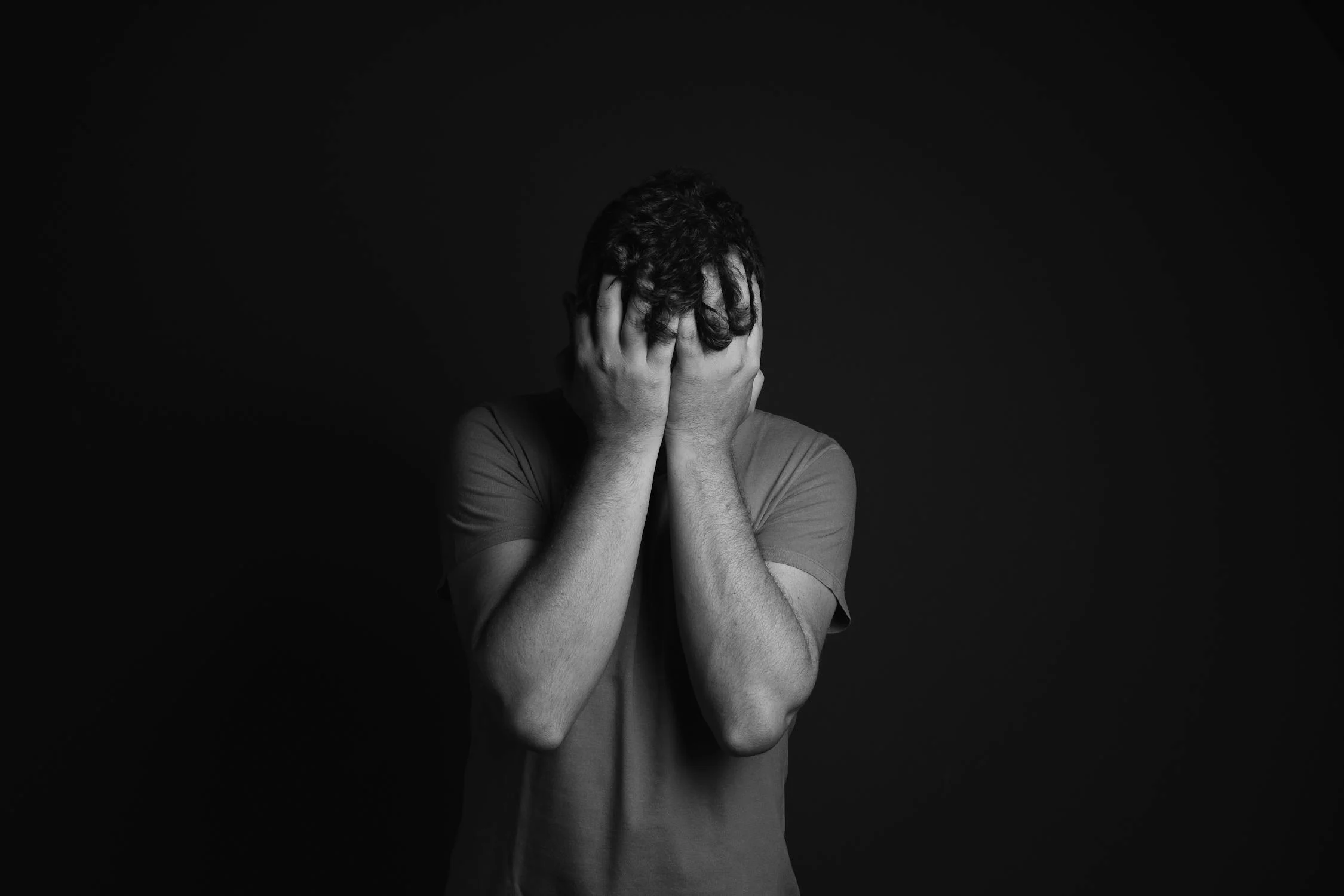 A man covering his face with his hands | Source: Pexels