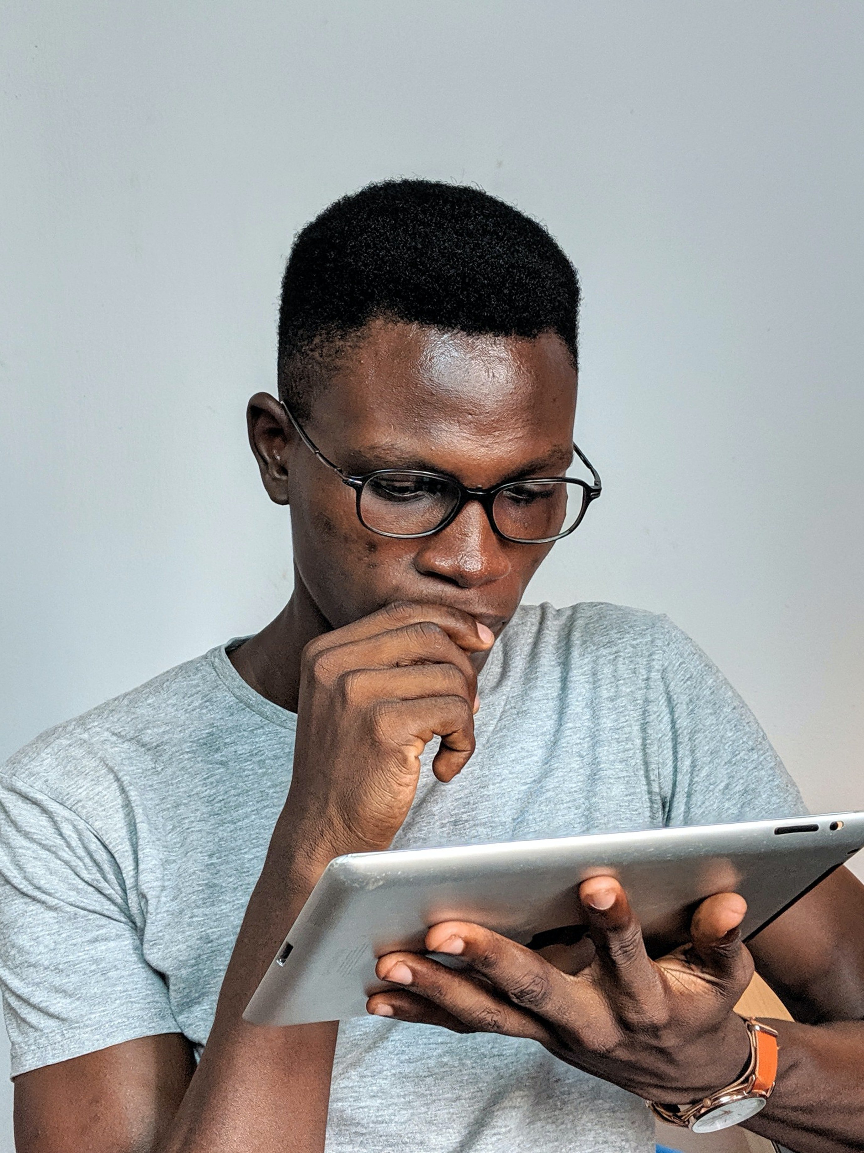 A man looking at an iPad. | Source: Pexels/  Oladimeji Ajegbile