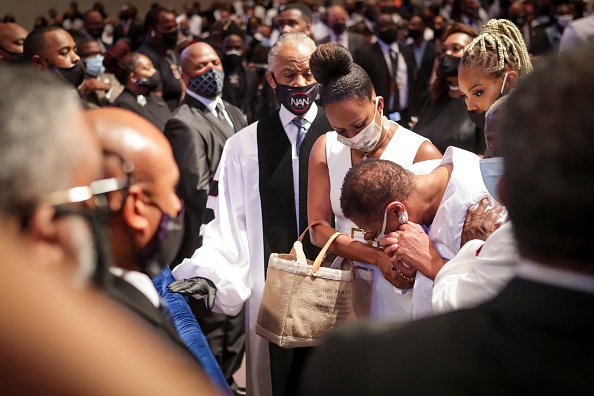 Mourners react during the funeral of George Floyd at The Fountain of Praise church on June 9, 2020 in Houston, Texas | Photo: Getty Images 