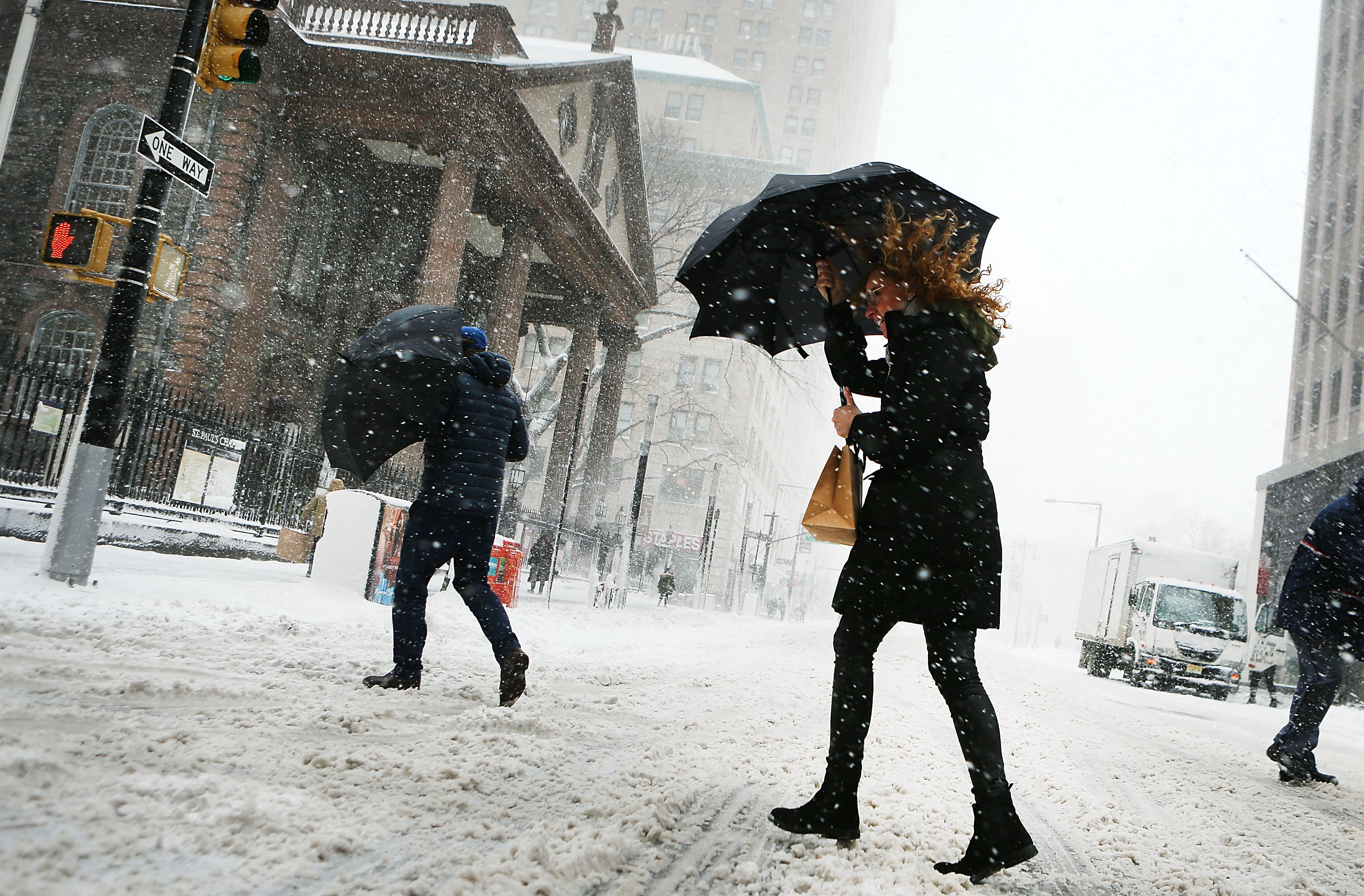 Pedestrians brave snow and wind on the street | Source: Getty Images