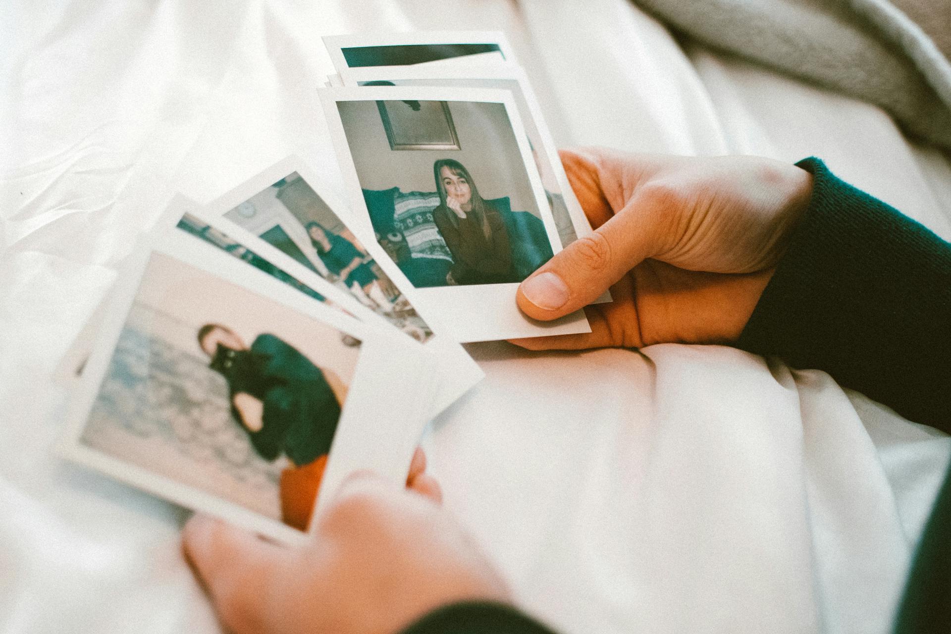 A person holding photographs | Source: Pexels