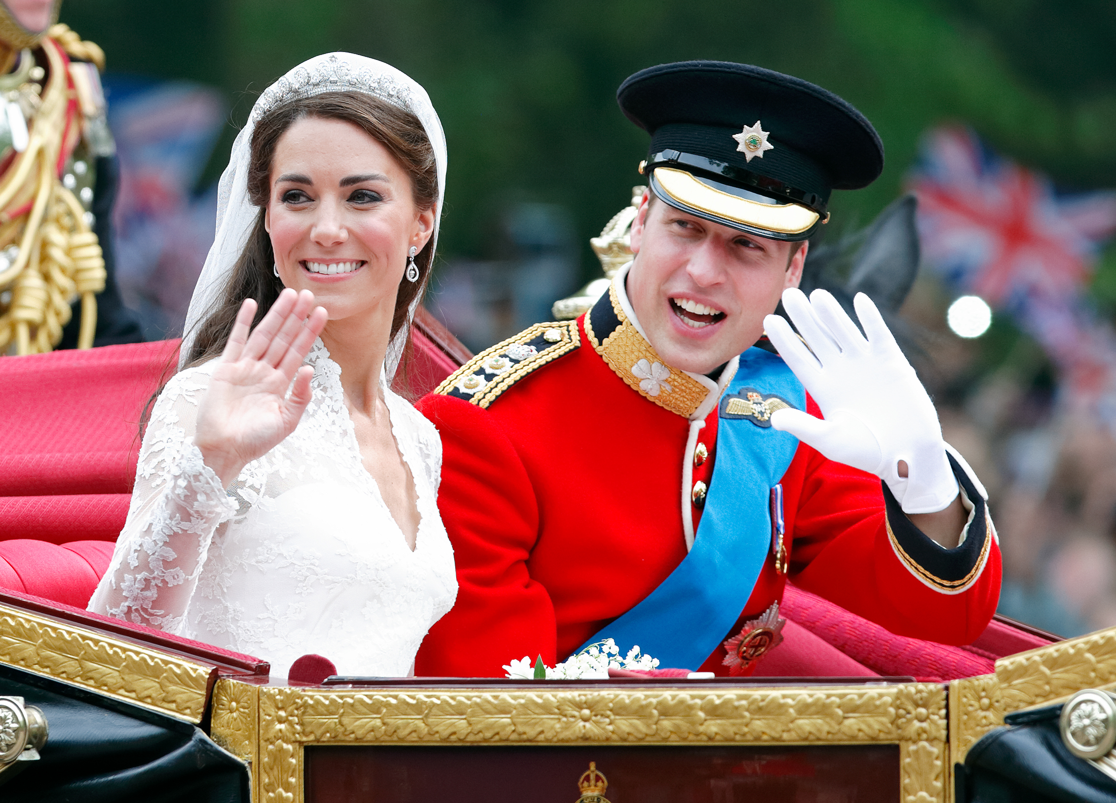 Fresh from exchanging vows, Kate Middleton and Prince William wave to cheering crowds as they ride through London, beginning their married life in one of the most memorable royal moments of a generation.