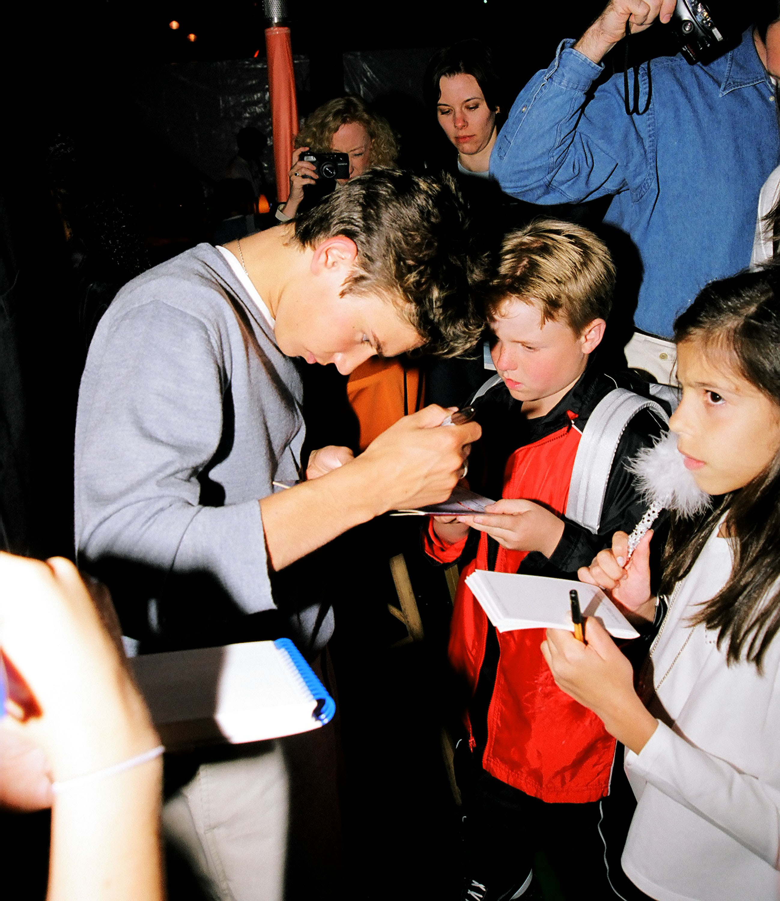 Jonathan Taylor Thomas signs autographs for young fans during the Kids' Choice Awards in Los Angeles, California.