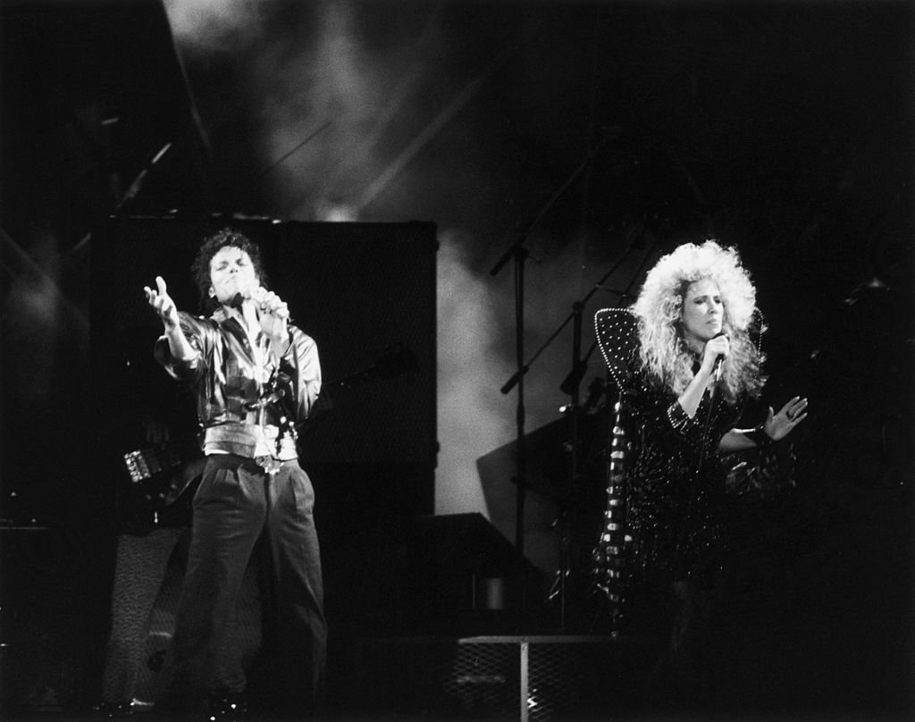 Michael Jackson teams up with backing singer Sheryl Crow for the duet 'I Just Can't Stop Loving You' during a 'Bad' World Tour concert in Japan | Photo: Getty Images