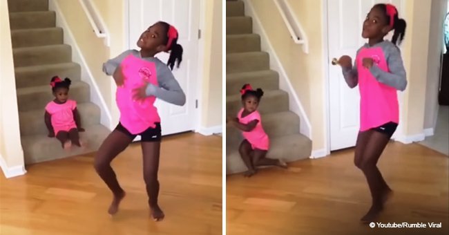 Toddler steals the show from big sister by dancing in the background in adorable video