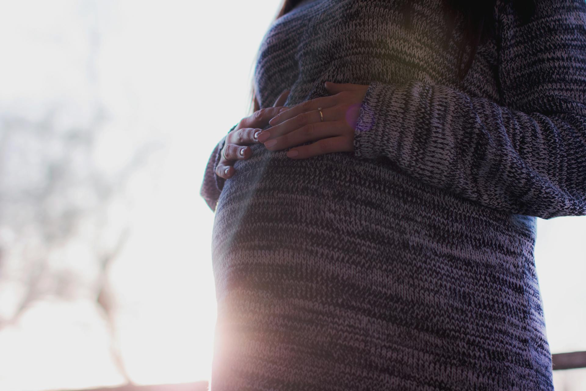 A pregnant woman touching her belly | Source: Pexels