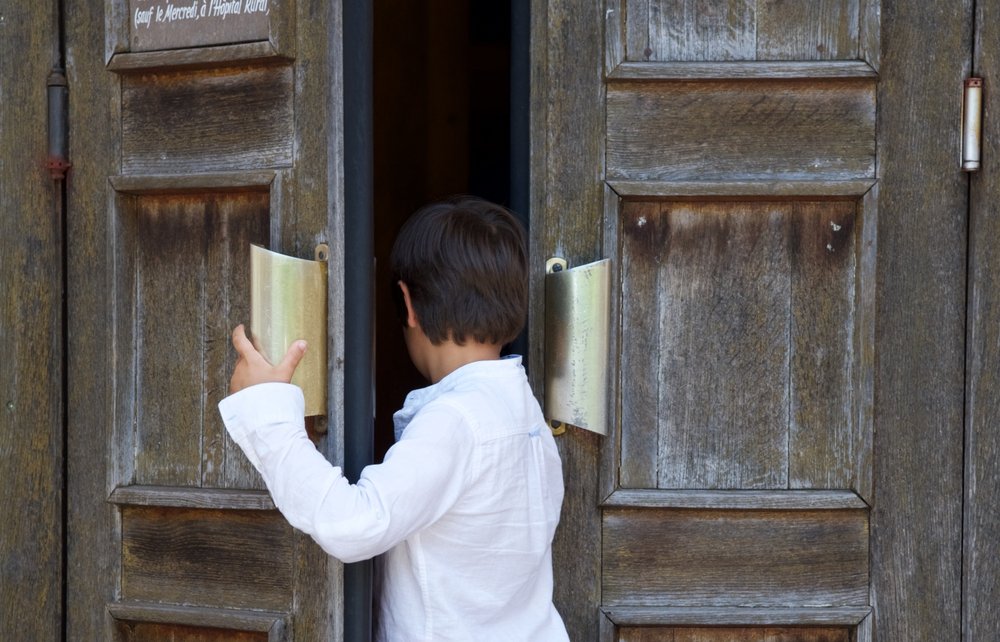 Un petit garçon entrant dans une église | Photo : Shutterstock Un petit garçon entrant dans une église | Photo : Shutterstock